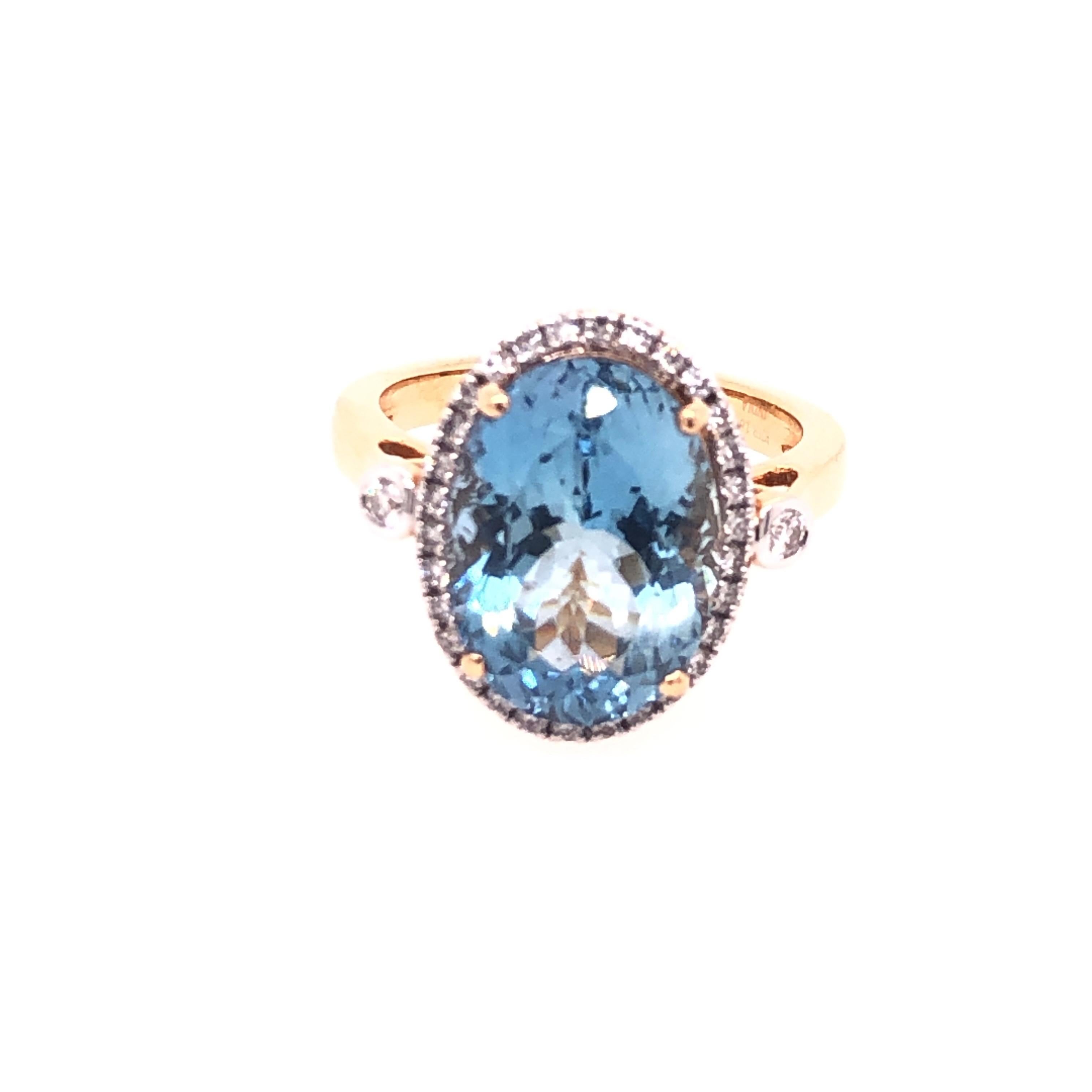 18K Yellow Gold and 6.40CTW Aquamarine-Oval Faceted with Diamond Halo and Diamond Side Stone. .33CTW Diamonds. Size 6.75