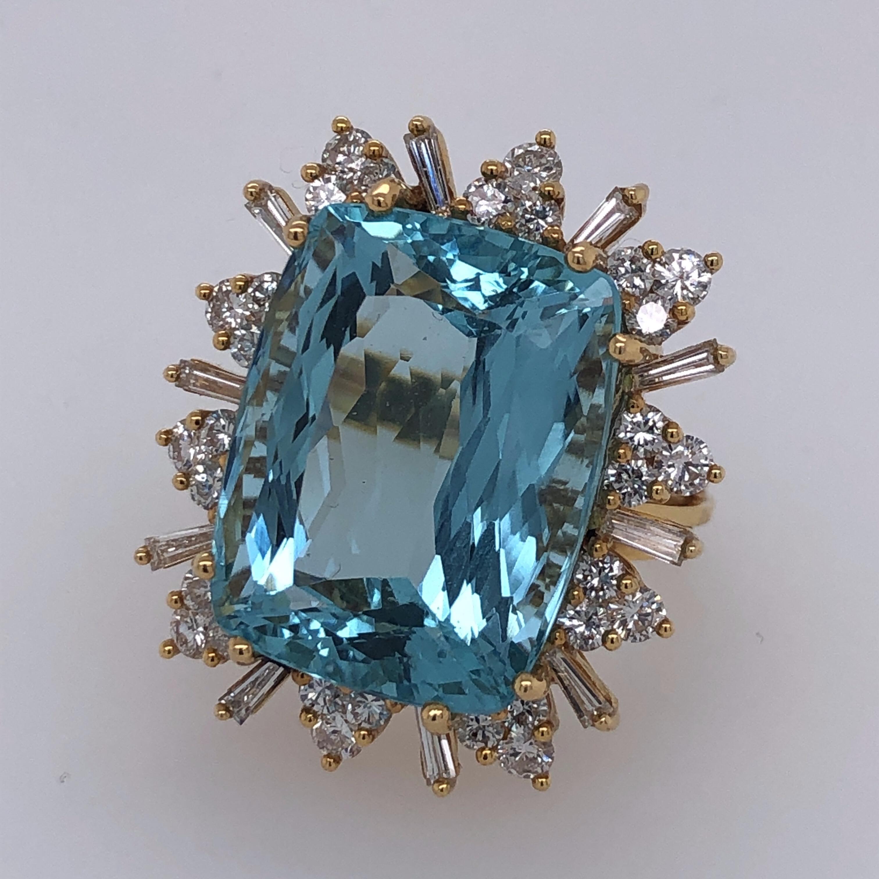 Lady's 18K yellow gold aquamarine and diamond fashion ring containing one approximately 25 carats cushion-cut aquamarine , 10 tapered baguette-cut diamonds approximately 3/4 carat total weight and 30 round full-out diamonds approximately 1-1/2