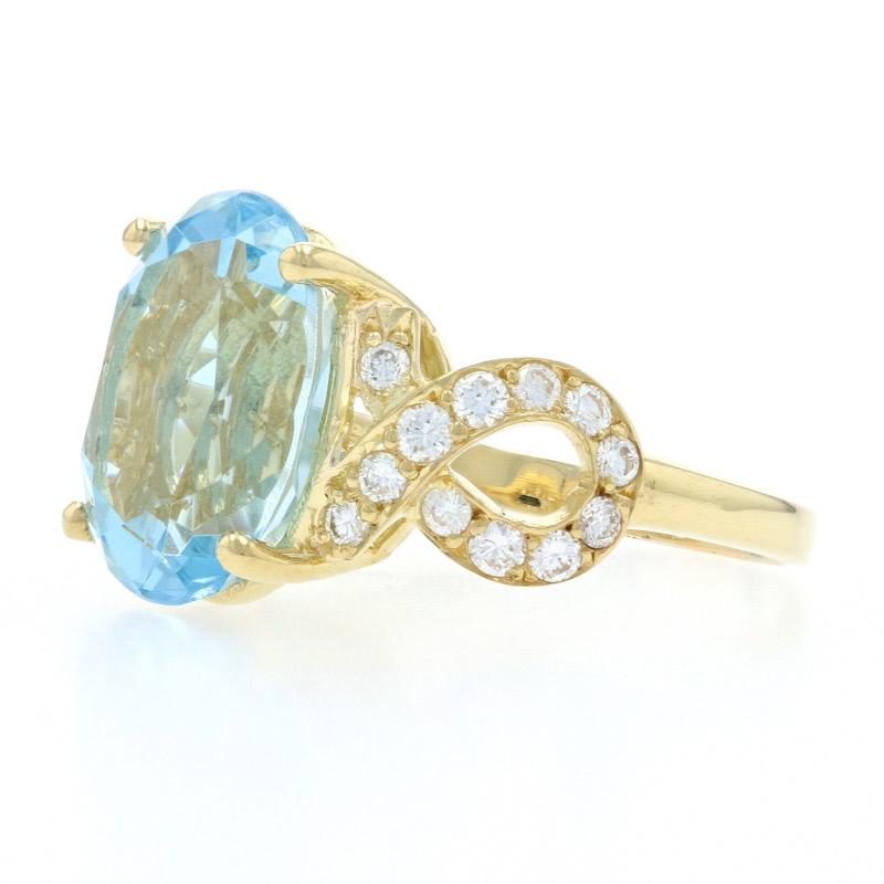 Red carpet glamour awaits with this stunning piece! Beautifully crafted in 18k yellow gold, this show-stopping ring features a dazzling aquamarine solitaire set between two sparkling white diamond ribbons.  

This ring is a size 7 1/2. Please