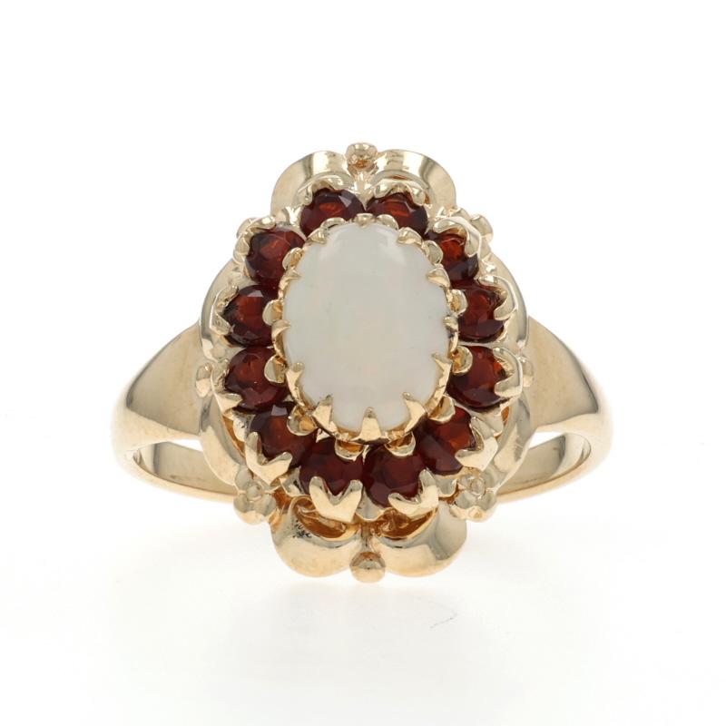 Taille : 6 1/2
Frais de taille : Up&Up 3 tailles pour $40 ou Down 2 tailles pour $30

Contenu du métal : Or jaune 10k

Informations sur les pierres

Opale naturelle d'Australie
Carat(s) : .80ct

Grenats naturels
Carat(s) : 1.08ctw
Coupe :