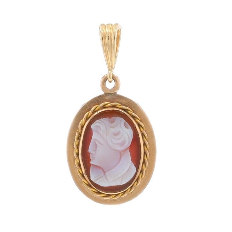 Era: Vintage

Metal Content: 14k Yellow Gold

Stone Information

Natural Banded Agate
Cut: Carved Cameo
Size: (approximately) 14mm x 10mm

Style: Solitaire
Theme: Figural Silhouette
Features: Rope Detailing

Measurements

Tall (from stationary