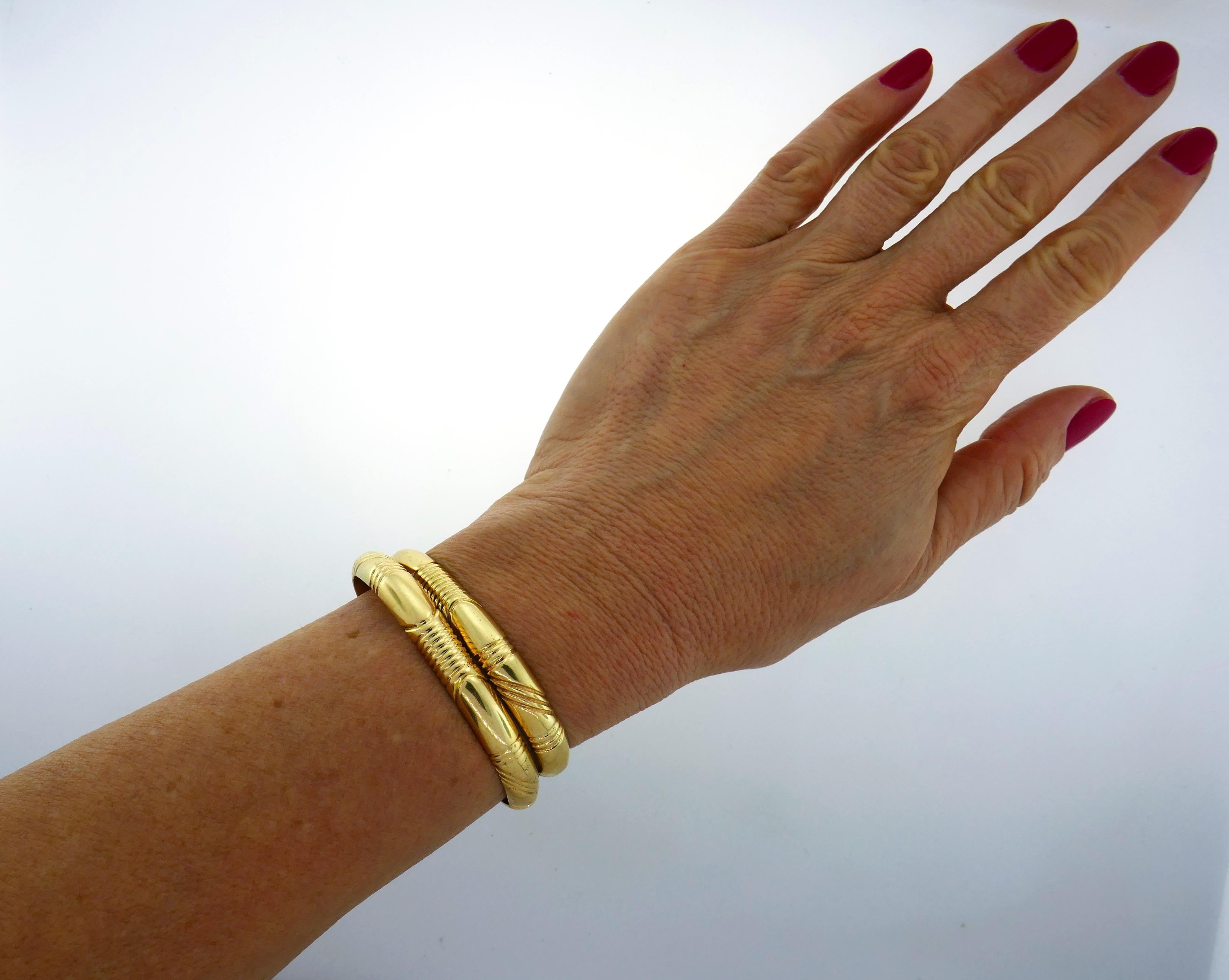 A pair of 14 karat yellow gold signed WB. Chic, timeless and wearable, the pair is a great addition to your jewelry collection. 
Each bangle is slightly over 1/4 inch (0.8 centimeters) wide and weighs 31.4 grams. The pair fits up to 6-1/8-inches