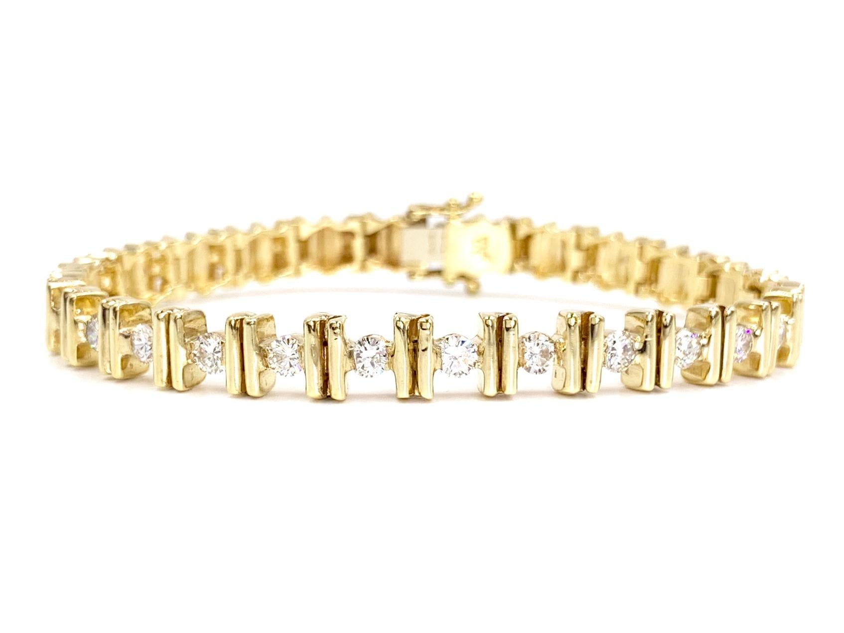 A 14 karat yellow gold polished bar design modern bracelet featuring 12 round brilliant diamonds at 1.21 carats total weight. Diamonds are approximately G color, VS2 clarity (eye clean) with generous sparkle. Bracelet fastens securely with a tongue