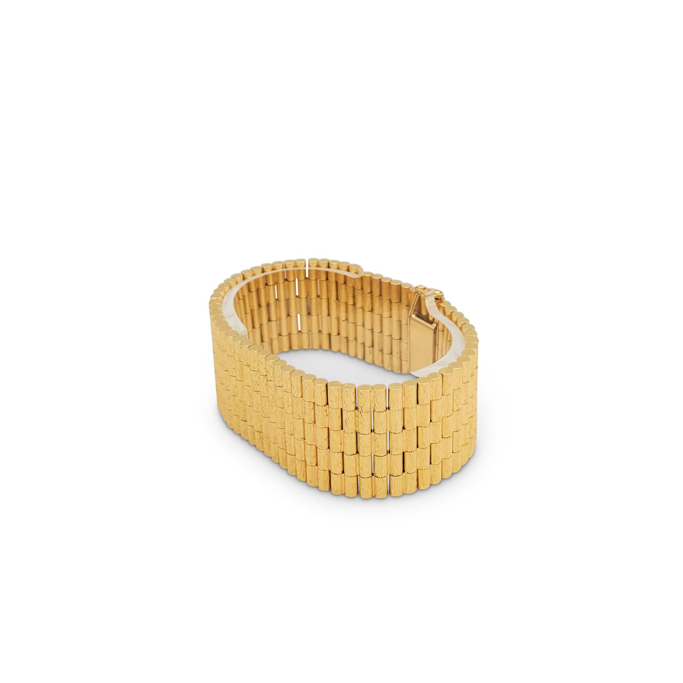 A wearable wide bracelet crafted in 18 karat gold comprised of cylindrical links that feature a bark finish. Indiscernible hallmarks present. The bracelet is not presented with the original box or papers. CIRCA 2000s.

Bracelet Length: 7 1/2