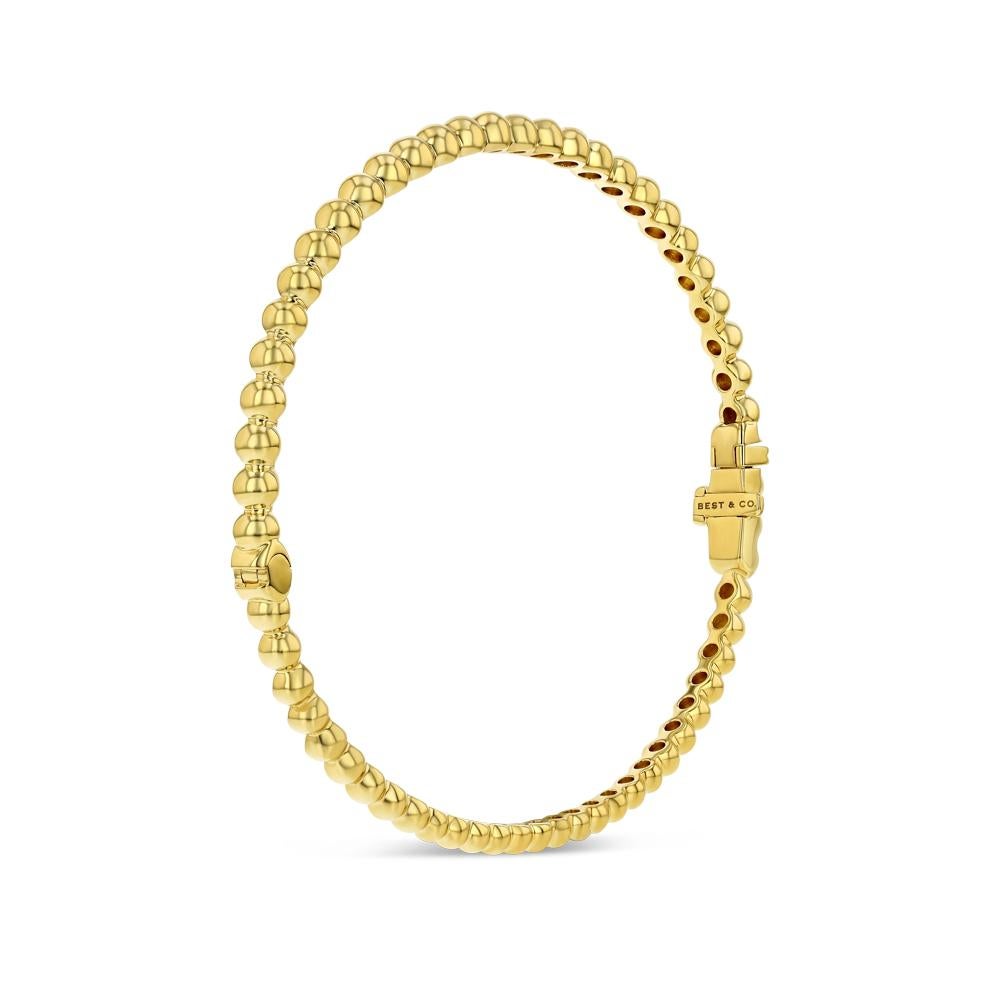 With half of its golden spheres one size, and the other half another, our Yellow Gold Bead Bangle offers a unique twist on a very in vogue style. Made of 18 karat yellow gold the dainty piece is one that is great for stacking, and can be dressed up