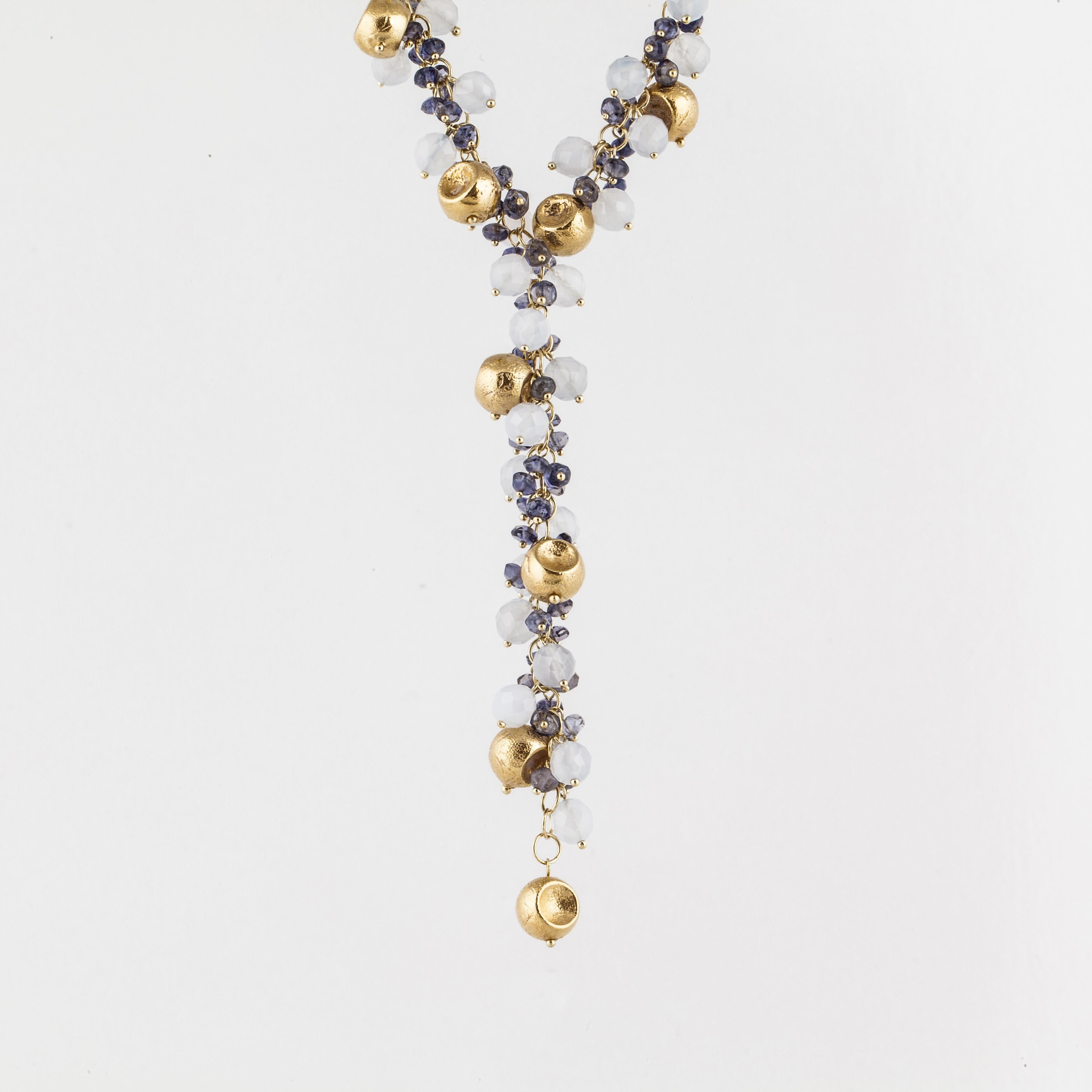 Vintage lariat style 18K yellow gold necklace with gold, sapphire and moonstone beads.  The yellow textured gold beads are concave on two sides.  There are 39 faceted moonstone beads and 90 sapphire beads.  The necklace measures 18 inches long and