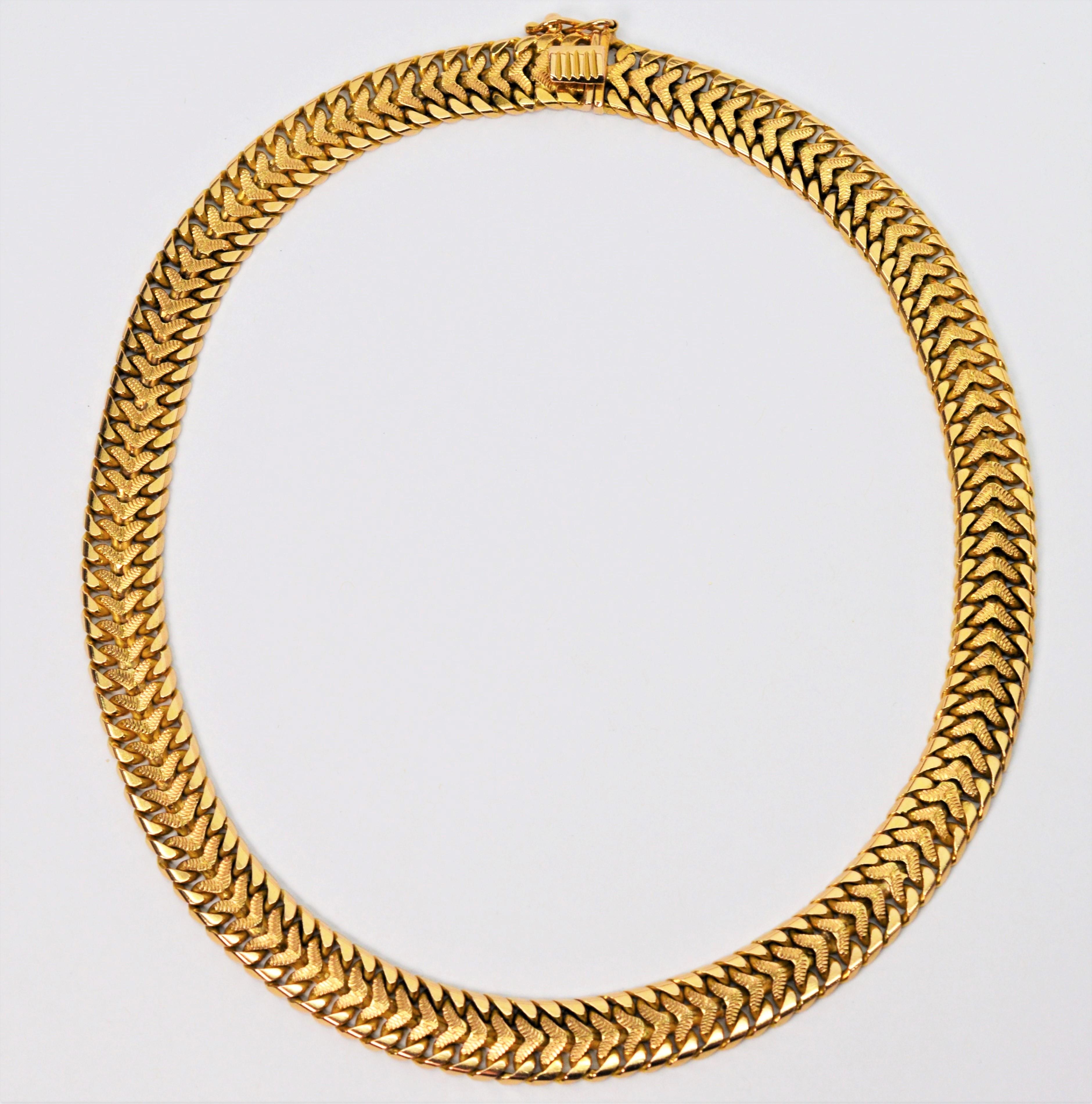 Keep it stylishly close to the neck with this striking fancy Bismark chain necklace in bright eighteen karat yellow gold. The intricate patterned weave has an interesting textured gold inner link framed by a bright outer link. This necklace makes a