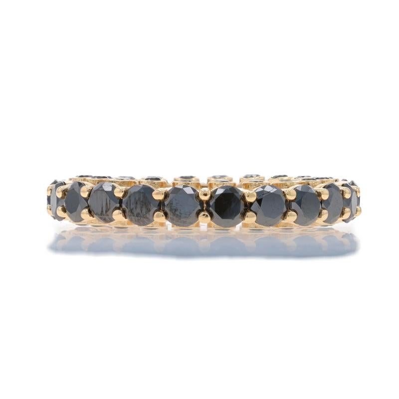 Size: 8

Metal Content: 14k Yellow Gold

Stone Information
Natural Diamonds
Treatment: Color Enhanced
Carat(s): 3.96ctw
Cut: Round Brilliant
Color: Black

Total Carats: 3.96ctw

Style: Eternity Band
Features: Diamond accents on both sides of the