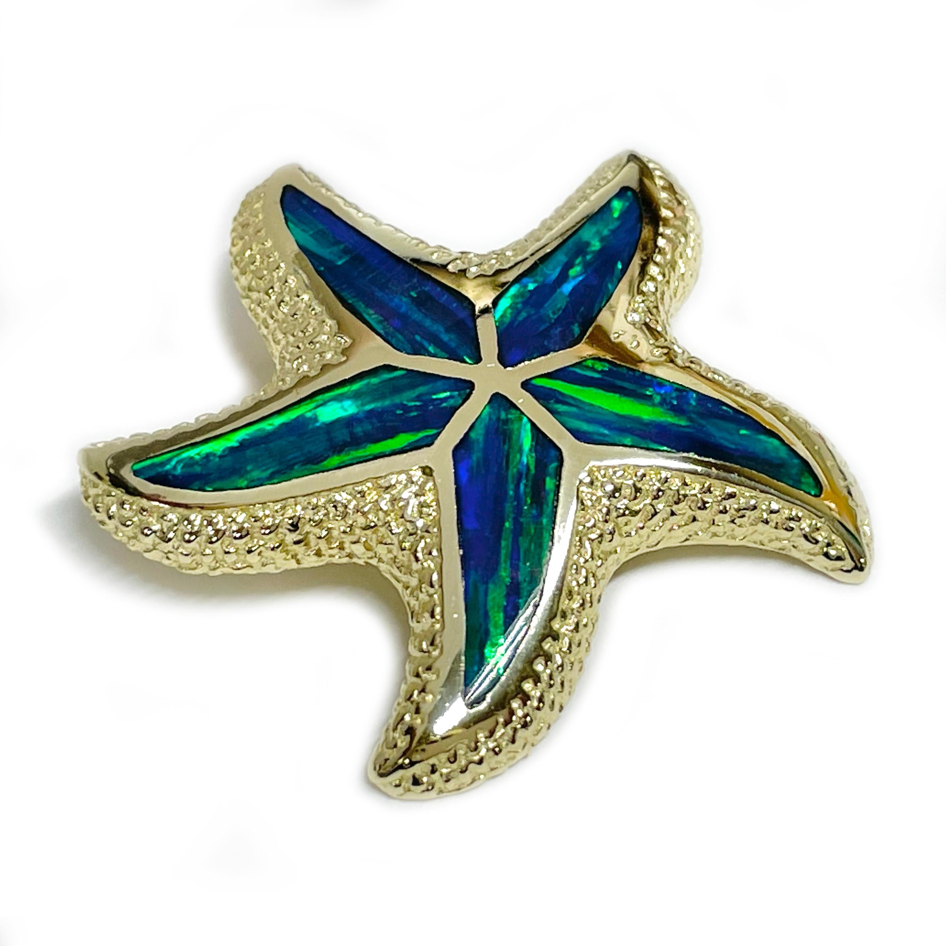 Yellow Gold Black Opal Starfish Pendant. The pendant has a textured finished along the edges and a smooth finish closer to the center where there are five black opal inlays that follow the shape of the star points. The opals have vibrant hues of