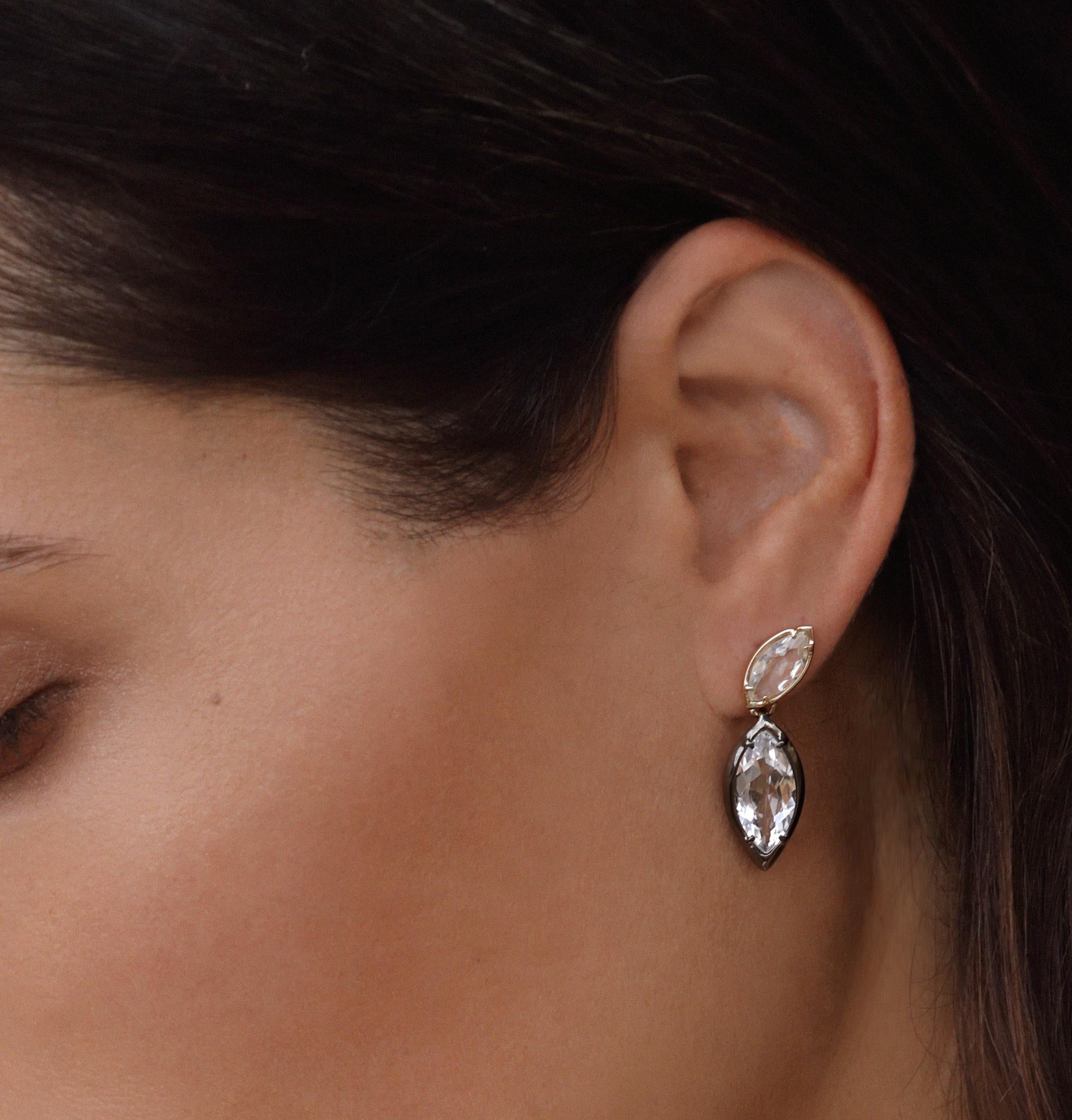 The Sway earrings are a dynamic asymmetrical design in an easy to wear silhouette with mixed metals featuring white topaz marquise stones.

14kt yellow gold tops
Sterling silver drops with blackened finish
Left & right earrings
14kt gold posts with