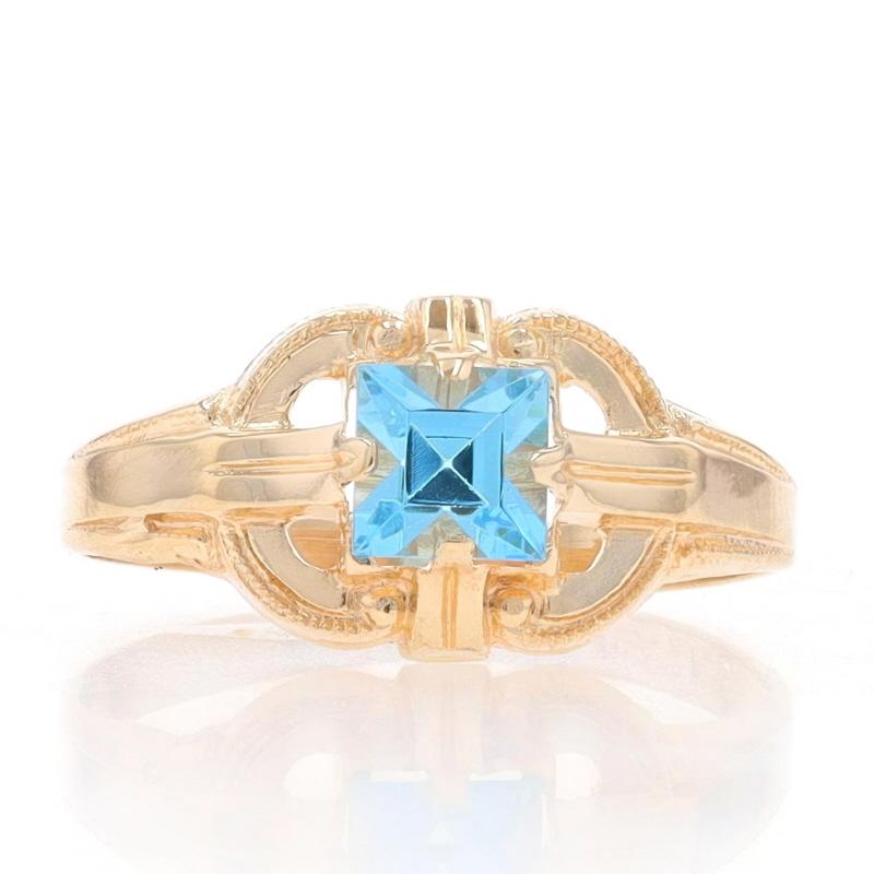 Size: 3
Sizing Fee: Up 2 sizes for $35 or Down 2 sizes for $30

Era: Art Deco
Date: 1920s - 1930s

Metal Content: 10k Yellow Gold

Stone Information
Glass
Cut: Square
Color: Blue
Size: 3.9mm (square)

Style: Solitaire
Features: Milgrain