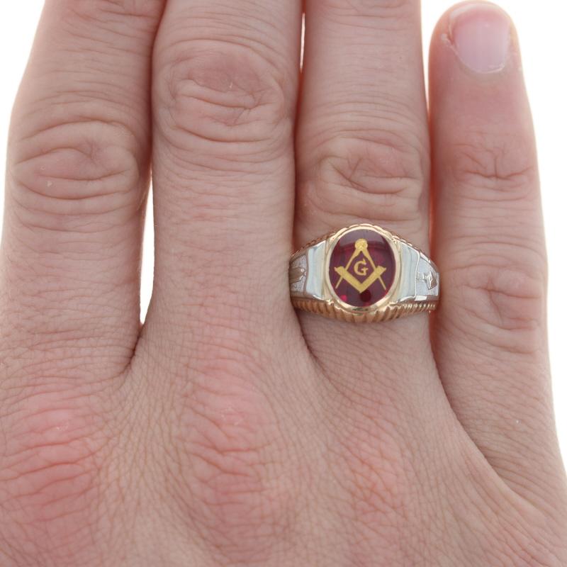 Size: 10 1/2
Sizing Fee: Down 1 size for $50 or up 2 sizes for $60

Organization: Blue Lodge

Metal Content: 10k Yellow Gold & 10k White Gold

Stone Information
Synthetic Ruby
Cut: Oval Cabochon 
Color: Red

Features: Smooth, ribbed, & textured