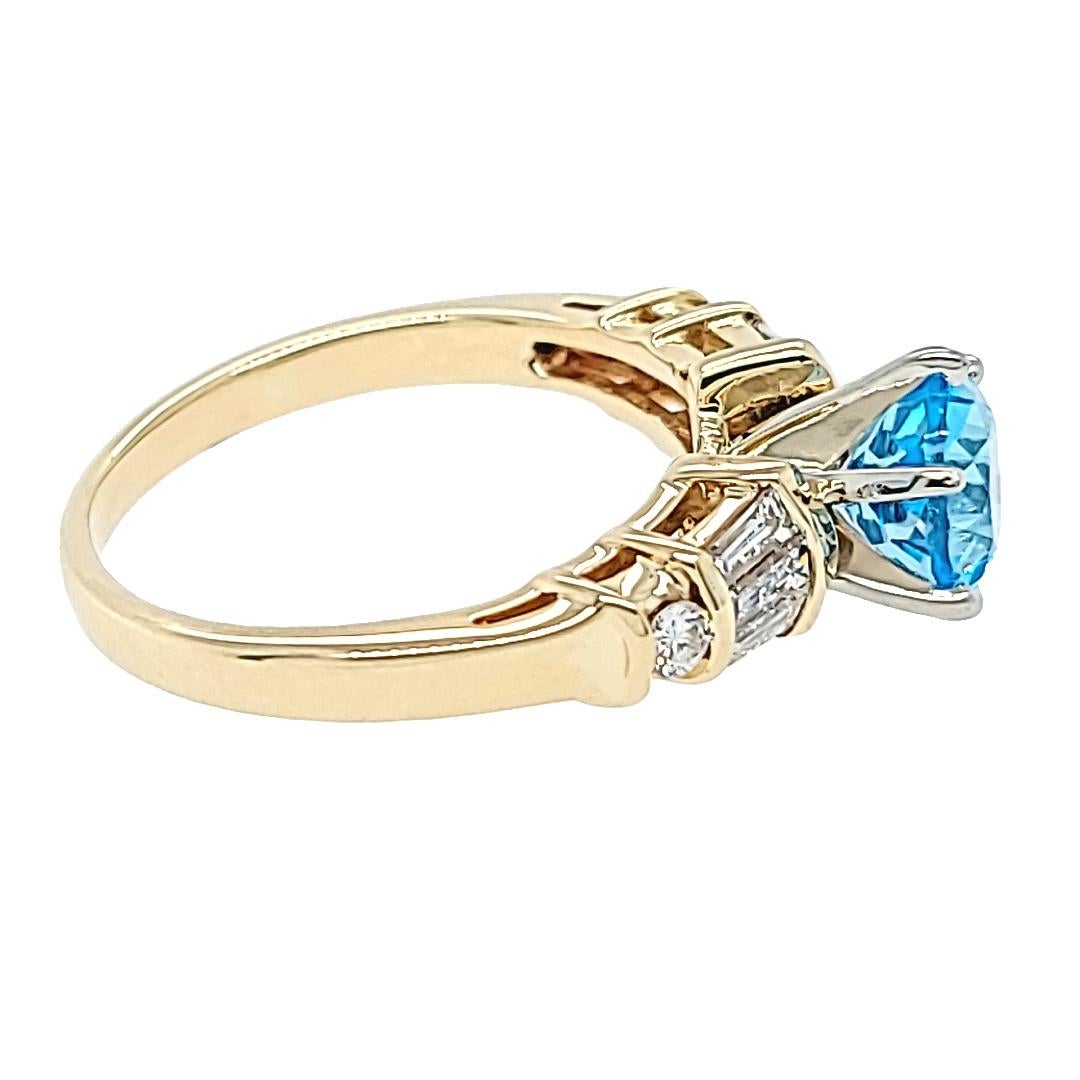 14 Karat Yellow Gold Ring Featuring A 1.63 Carat Round Blue Topaz Accented By 6 Baguette Cut Diamonds and 2 Round Brilliant Cut Diamonds of VS Clarity and H Color Totaling 0.50 Carats. Finger Size 7; Purchase Includes One Sizing Service Prior to