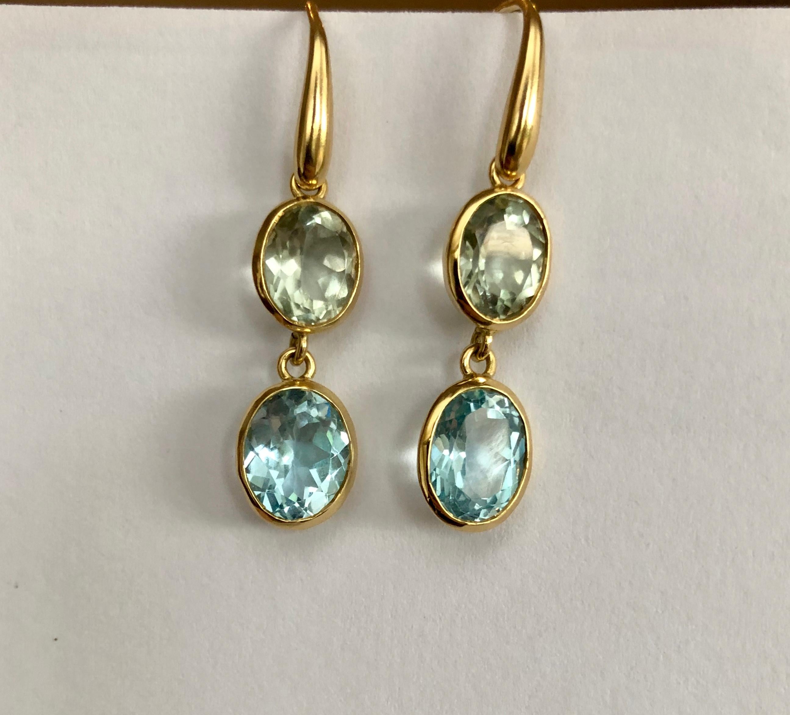 Indian Ocean Earrings - Stylish and elegant this stunning pair of earrings is made from 18kt yellow gold and semi precious stones. Designed and carefully hand crafted in the UK.

18 karat yellow gold
6.4 grams 
Blue Topaz & Prasiolite (green