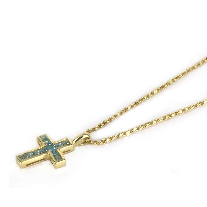 A blue topaz cross pendant and chain in 18k yellow gold. The cross is composed of 11 princess cut blue topaz totalling 1.10ct, within an 18k yellow gold surround. The pendant is 2.5cm in length and 1.3cm in width. The pendant is set upon an 18k