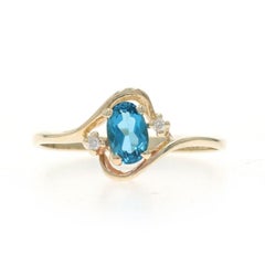 Yellow Gold Blue Topaz Diamond Bypass Ring - 10k Oval .62ctw