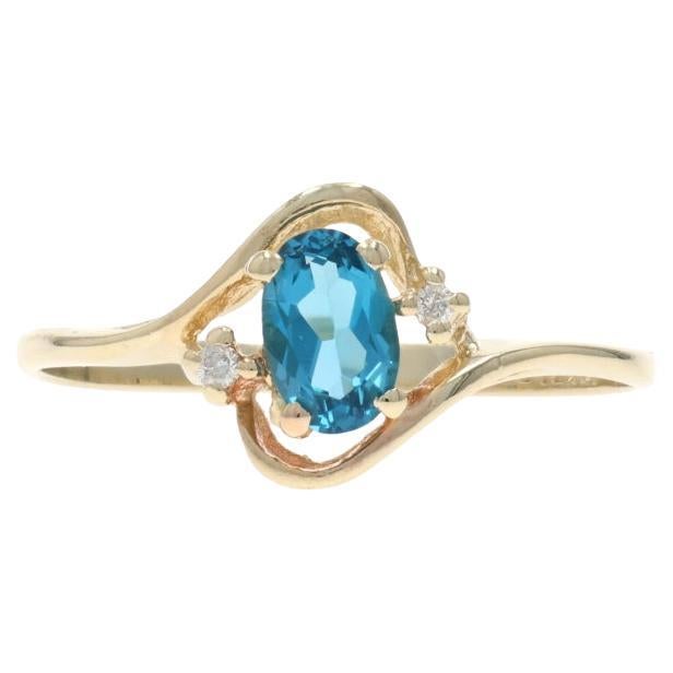 Bague bypass en or jaune avec topaze bleue et diamant - 10k Oval .62ctw