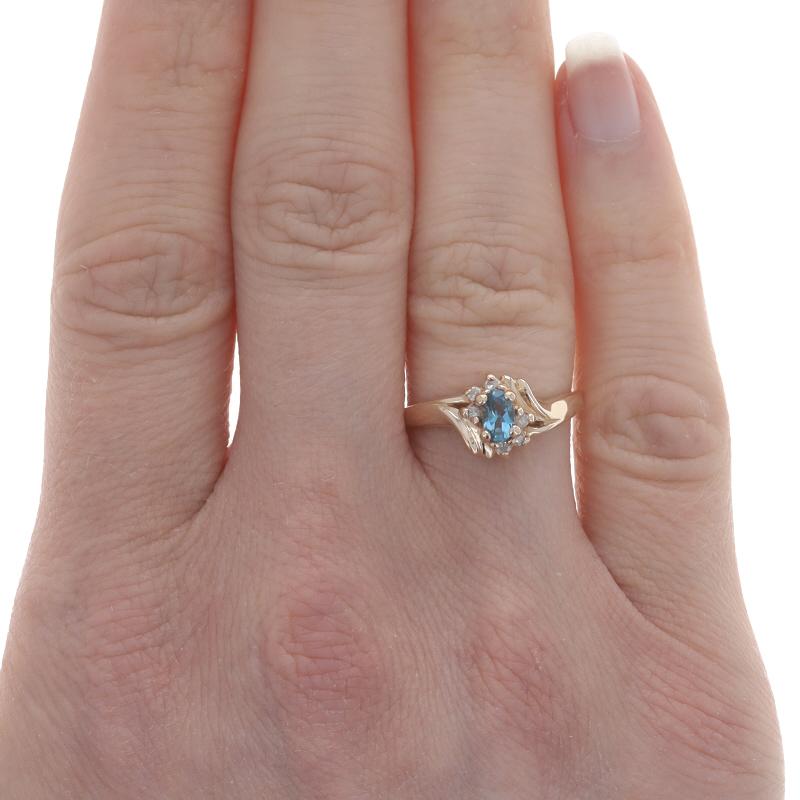 Oval Cut Yellow Gold Blue Topaz & Diamond Bypass Ring - 10k Oval .64ctw For Sale