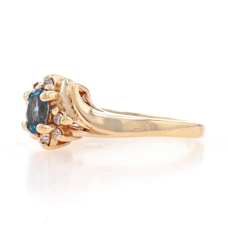 Yellow Gold Blue Topaz & Diamond Bypass Ring - 10k Oval .64ctw In Excellent Condition For Sale In Greensboro, NC