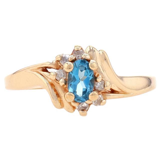 Yellow Gold Blue Topaz & Diamond Bypass Ring - 10k Oval .64ctw For Sale