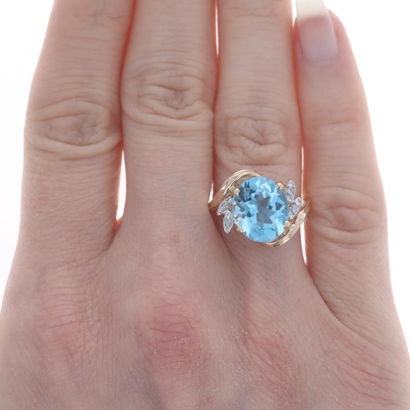 Size: 6 3/4
Sizing Fee: Up 2 sizes for $35 or Down 2 sizes for $30

Metal Content: 14k Yellow Gold & 14k White Gold

Stone Information
Natural Blue Topaz
Treatment: Routinely Enhanced
Carat(s): 4.75ct
Cut: Oval

Natural Diamonds
Carat(s):