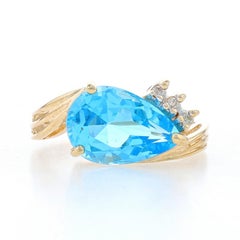 Bague bypass en or jaune avec topaze bleue et diamants - poire 14 carats 6,53 ctw Est-Ouest