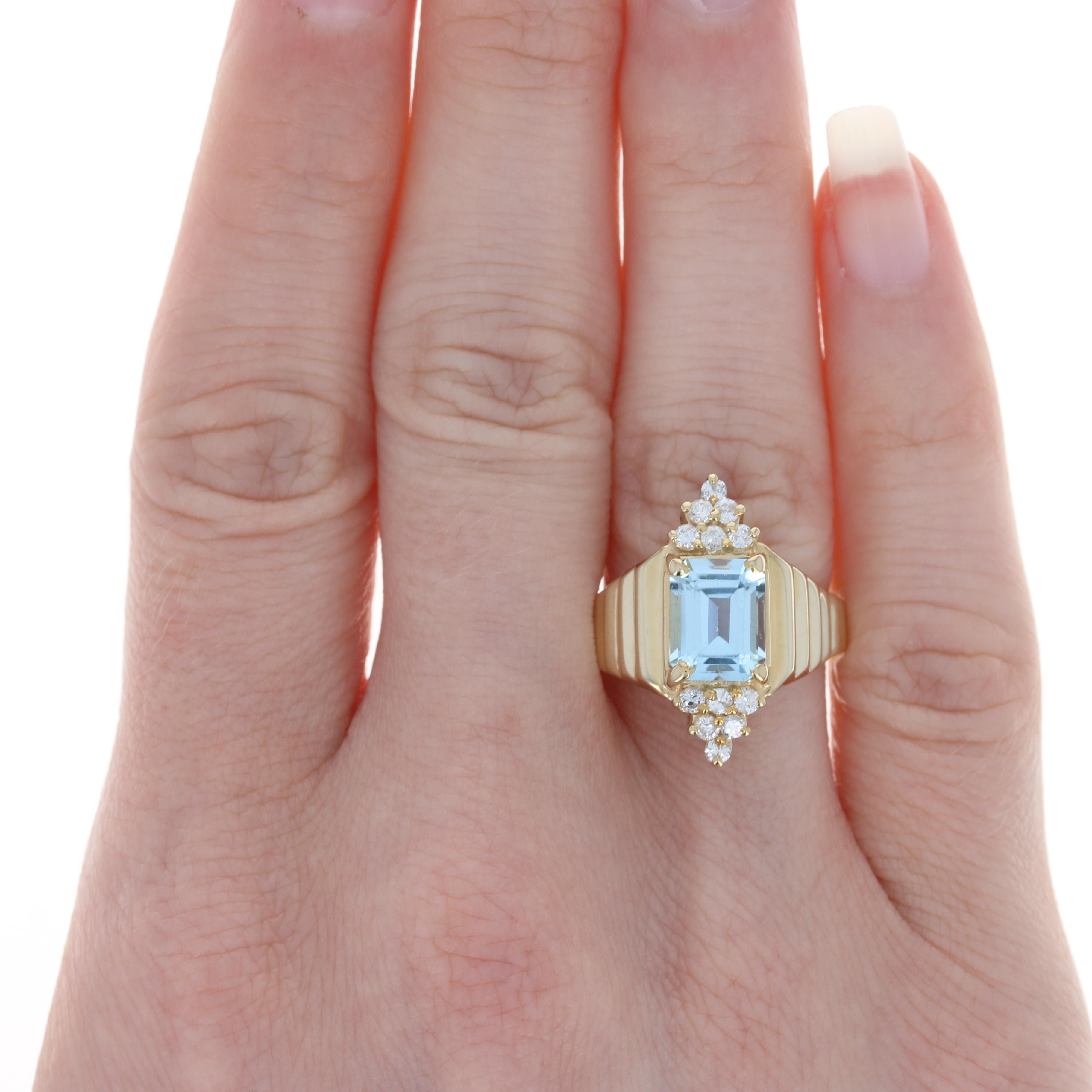 This radiantly beautiful treasure is destined to become a favorite addition to your jewelry collection! Fashioned in 14k yellow gold, this ring showcases an emerald cut blue topaz solitaire that is highlighted by two glittering clusters of icy white