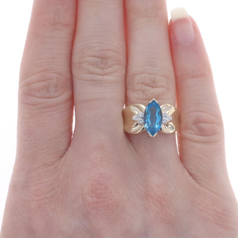 Size: 6 3/4
Sizing Fee: Up 3 sizes for $35 or Down 2 1/2 sizes for $30

Metal Content: 14k Yellow Gold & 14k White Gold

Stone Information

Natural Blue Topaz
Treatment: Routinely Enhanced
Carat(s): 1.75ct
Cut: Marquise

Natural Diamonds
Carat(s):