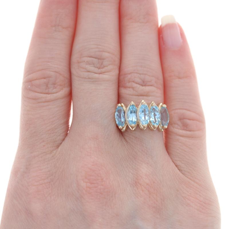 Size: 6 1/4
Sizing Fee: Down 2 for $30 or up 2 for $35

Metal Content: 14k Yellow Gold

Stone Information
Natural Topaz
Treatment: Routinely Enhanced
Carat(s): 3.75ctw
Cut: Marquise
Color: Blue

Total Carats: 3.75ctw

Style: Five-Stone
Features: