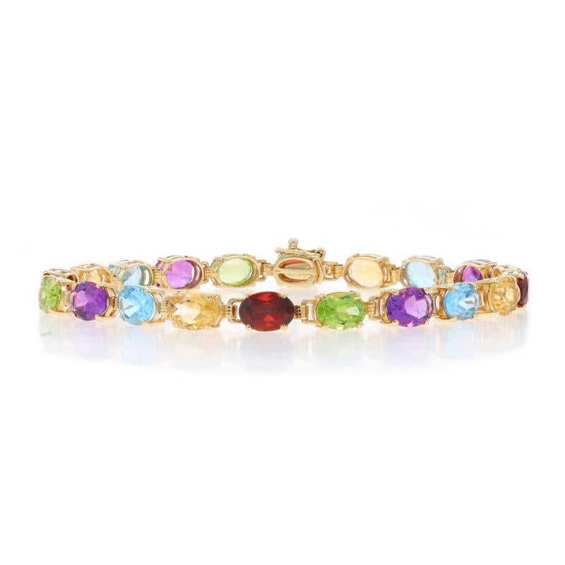Metal Content: 10k Yellow Gold

Stone Information

Natural Blue Topaz
Treatment: Routinely Enhanced
Carat(s): 4.40ctw
Cut: Oval

Natural Garnets
Carat(s): 4.00ctw
Cut: Oval
Color: Red

Natural Peridot
Carat(s): 3.80ctw
Cut: Oval
Color: