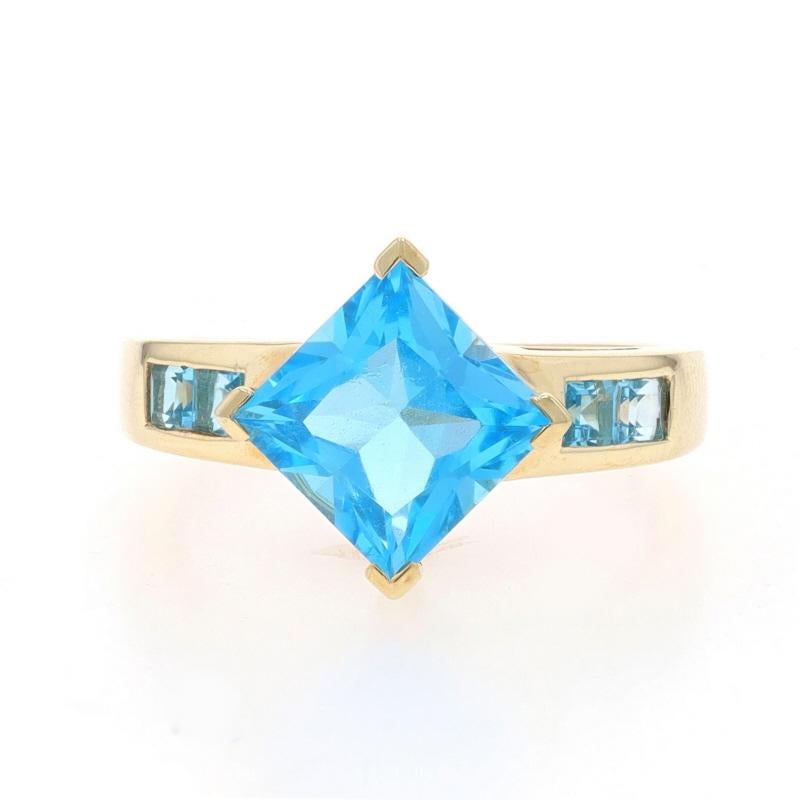 Size: 7 1/4

Metal Content: 10k Yellow Gold

Stone Information

Natural Blue Topaz
Treatment: Routinely Enhanced
Carat(s): 3.38ctw
Cut: Princess & Square

Total Carats: 3.38ctw

Style: Solitaire with Accents
Features: Channel Set