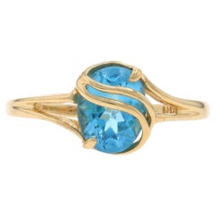 Yellow Gold Blue Topaz Solitaire Bypass Ring - 10k Oval 1.60ct