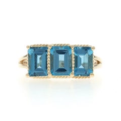 Yellow Gold Blue Topaz Three-Stone Ring - 10k Emerald 3.75ctw