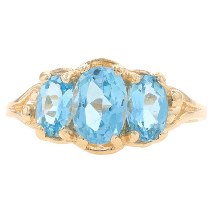 Yellow Gold Blue Topaz Three-Stone Ring - 10k Oval 1.95ctw For Sale