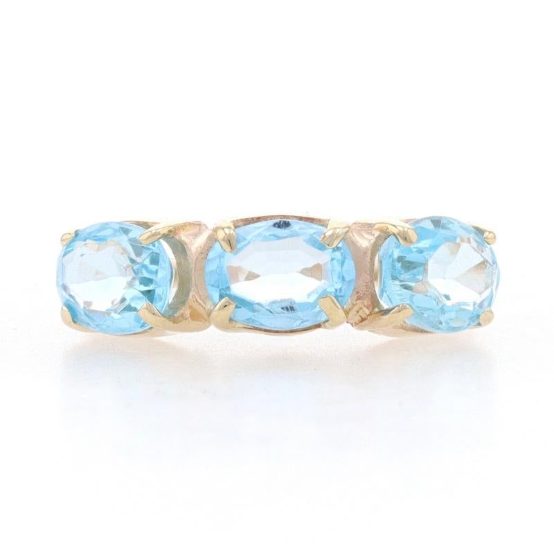 Size: 6 1/2
Sizing Fee: Down 1 for $30 or up 2 for $35

Metal Content: 14k Yellow Gold

Stone Information
Natural Blue Topaz
Treatment: Routinely Enhanced
Carat(s): 3.60ctw
Cut: Oval

Total Carats: 3.60ctw

Style: Three-Stone 
Features:  East-West