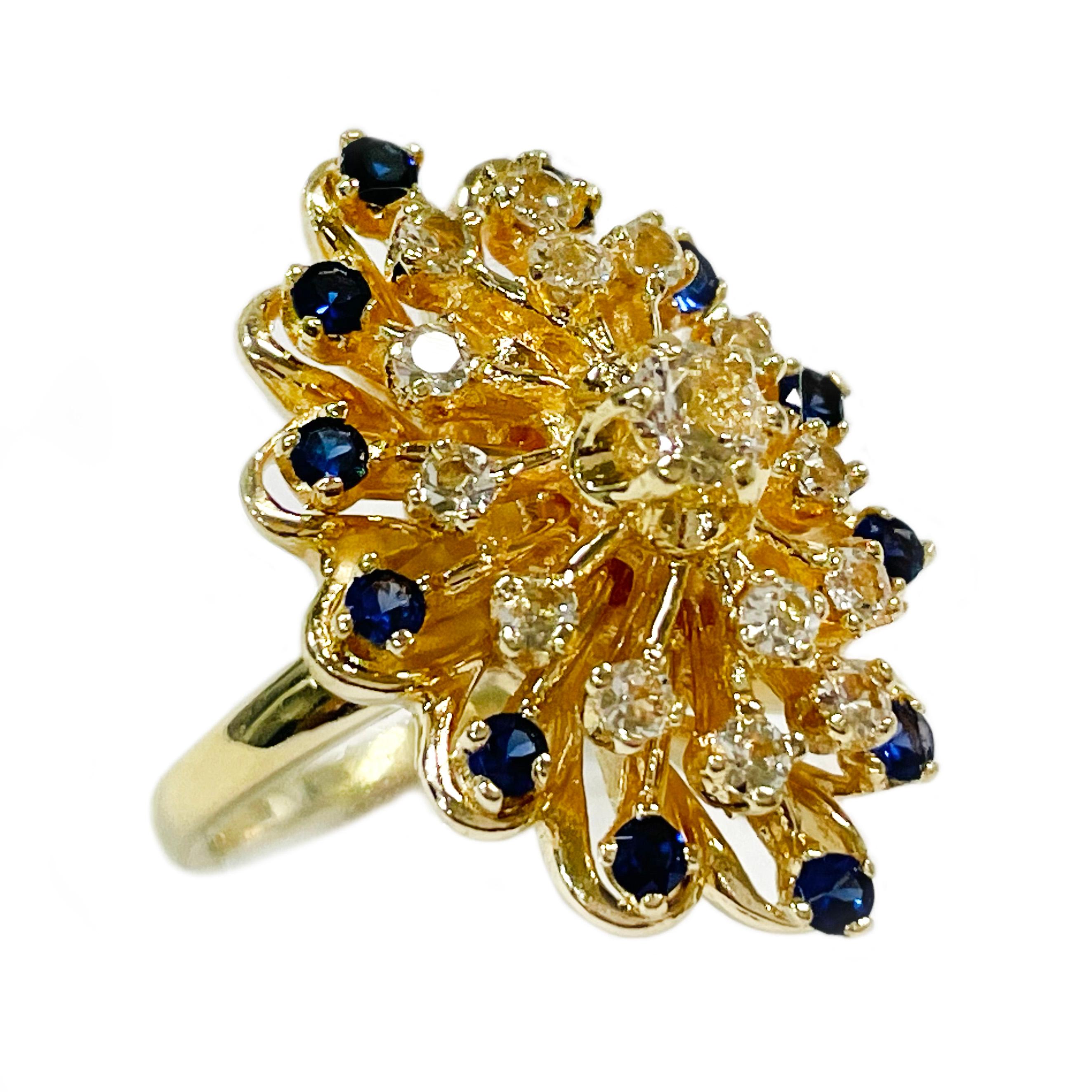 14 Karat Yellow Gold Blue & White Cluster Ring. This stunning and super shiny ring features fifteen round white sapphires and twelve round medium blue sapphires, all prong-set in multi-tiered branch-like arms that stem from a flower-shaped base