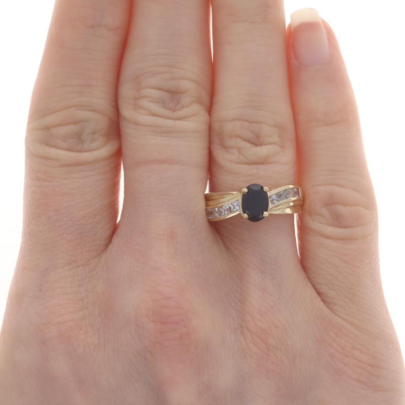Size: 7
Sizing Fee: Up 1/2 a size for $30 or Down 1/2 a size for $30

Metal Content: 14k Yellow Gold

Stone Information

Natural Sapphire
Treatment: Heating
Carat(s): 1.00ct
Cut: Oval
Color: Dark Blue

Natural Sapphires
Treatment: Heating
Carat(s):