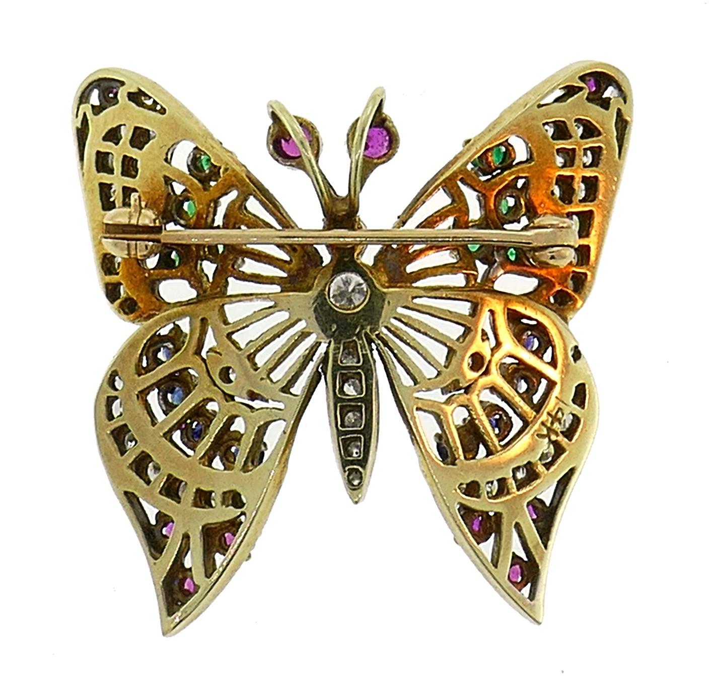 Lovely colorful butterfly pin created in the 1950s. 
Made of 14 karat (stamped) yellow and white gold, set with diamonds, rubies, sapphires and emeralds. The diamonds are single and Old European cuts, G-H color VS clarity, total weight approximately