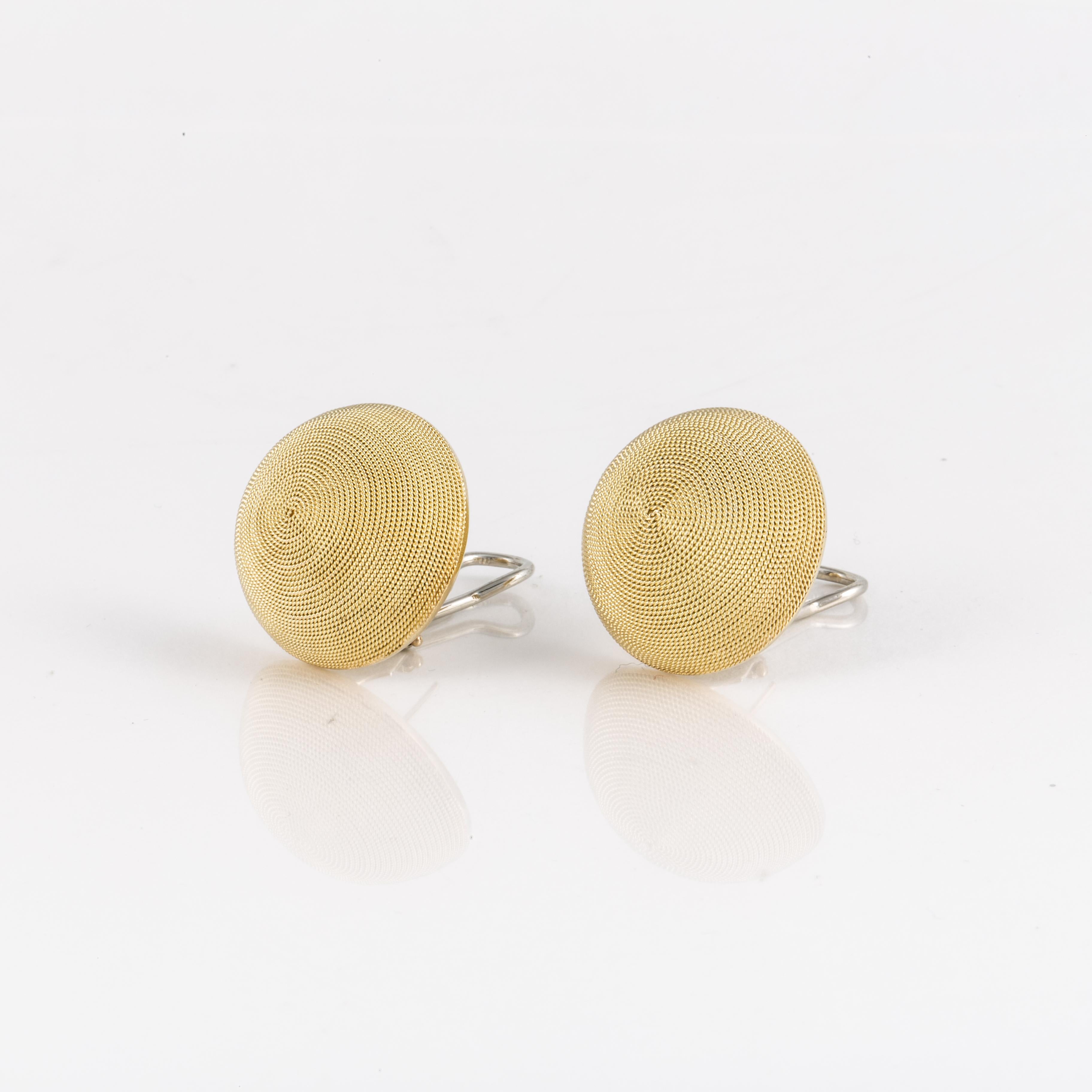 18K yellow gold button earrings with a beautiful textured finish.  Measure 1 inch across and stand 7/16 inches off the ear.  They are for pierced ears with an omega back. 