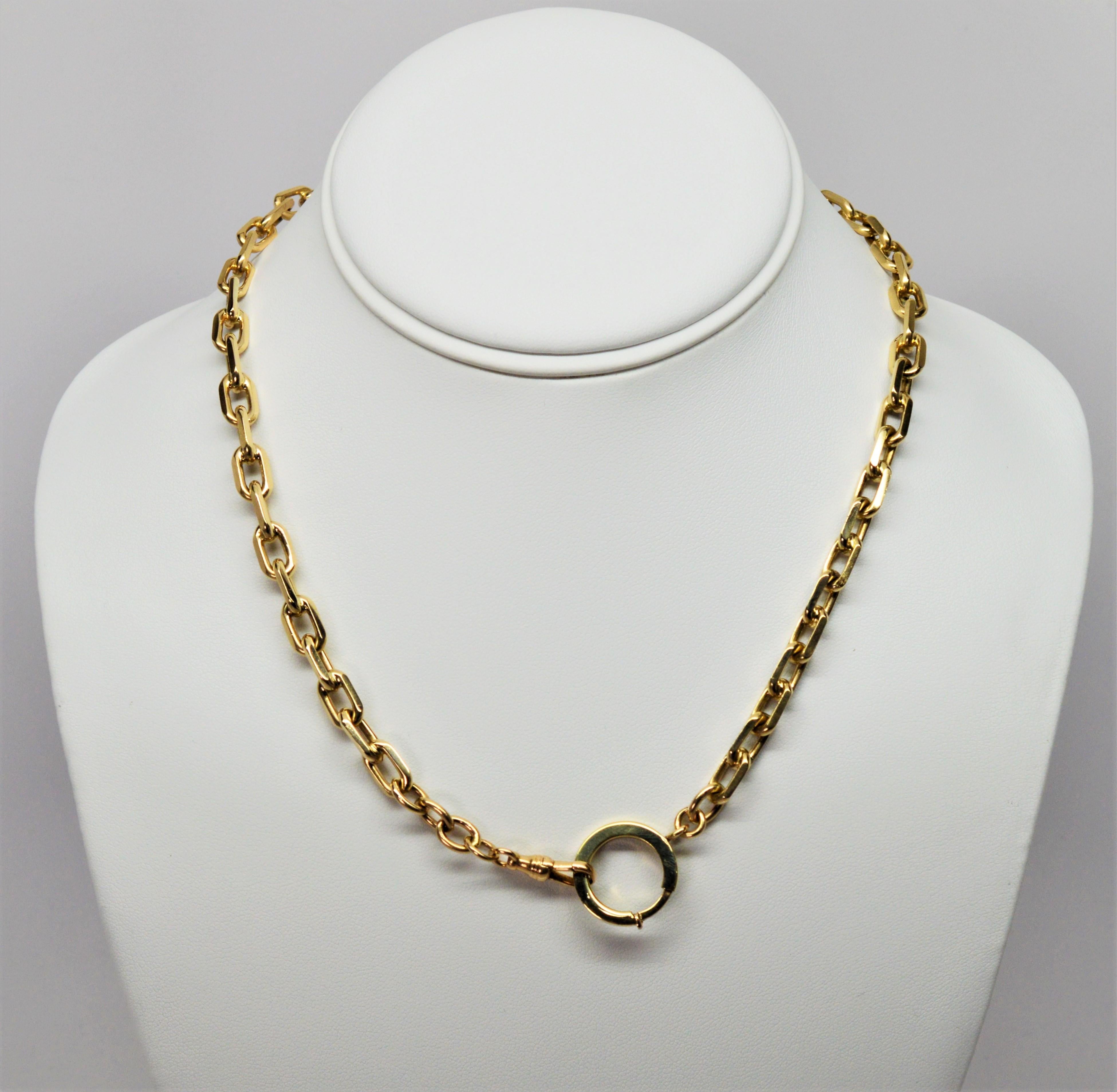 In a lengthy seventeen inches, this heavy weight fourteen karat 14K yellow gold pocket watch twin link cable chain is fitted with a 1/2 inch spring ring and a latch clip. Can be worn as a necklace chain as well. Stamped 14K by maker. In excellent