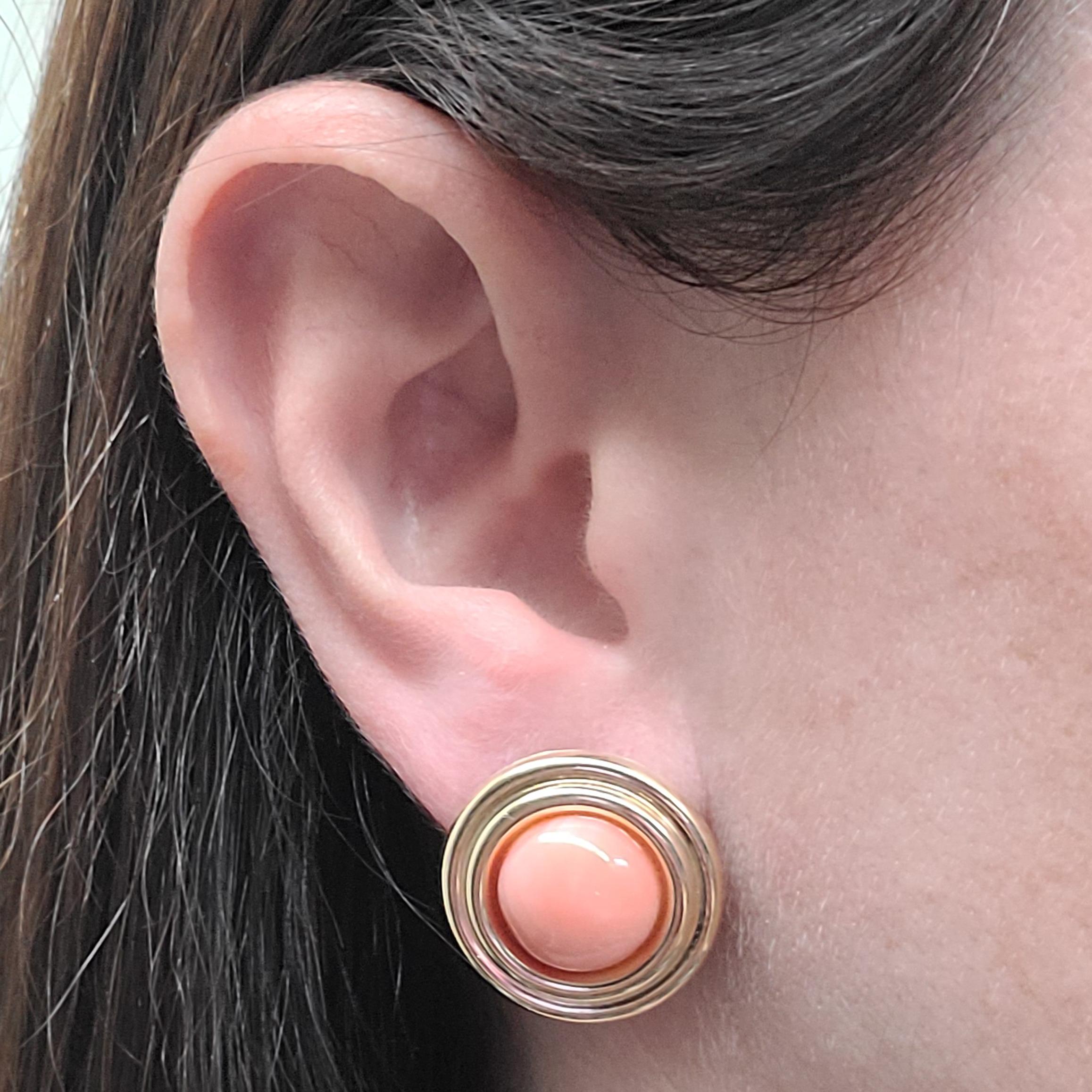 14 Karat Yellow Gold Earrings Featuring 12mm Round Cabochon Corals. Pierced Post With Omega Clip Back For A Supportive Hold. Finished Weight Is 4.6 Grams.