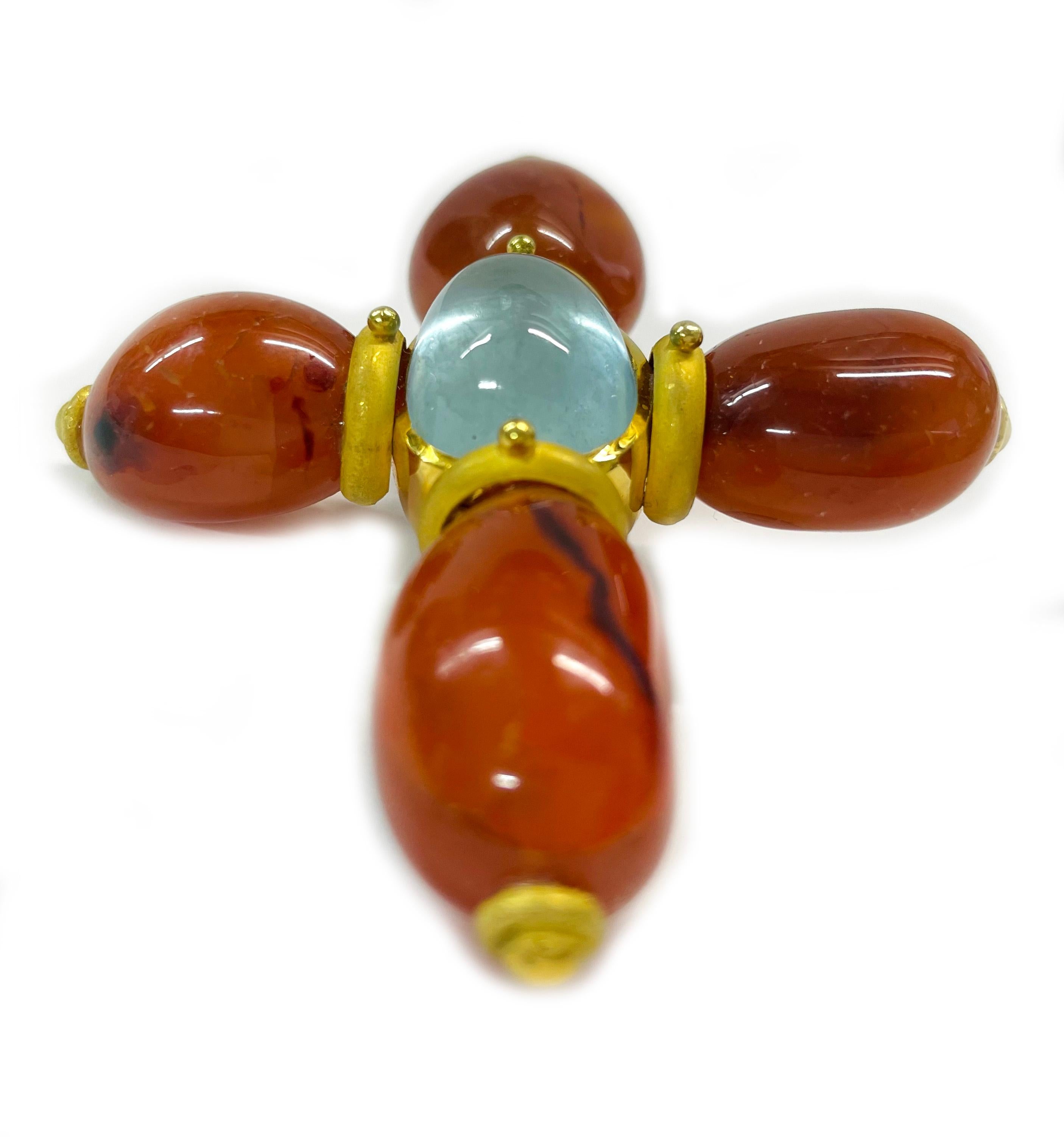 18K Yellow Gold Carnelian Aquamarine Cross Pendant. The pendant features four organic shaped polished Carnelian stones and an oval-shaped aquamarine set in an open bezel at the center forming a cross shape. This is a substantial sized pendant with