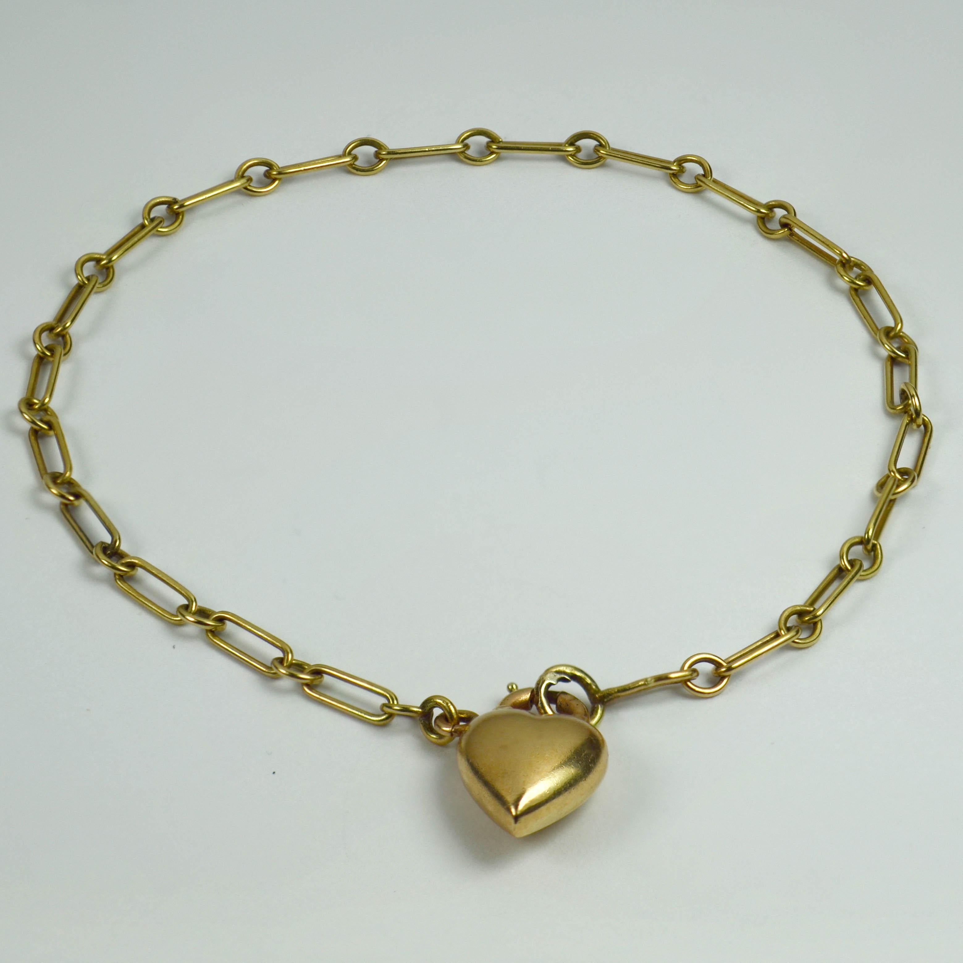 A 14 karat yellow gold belcher chain link bracelet with an 18 karat yellow gold puffy heart padlock charm as a clasp. Marked 14K and 18K. Bracelet measures 7 inches in length.

Dimensions:
Bracelet: 19 x 0.3 cm
Heart Padlock: 1.5 x 0.9 x 0.5