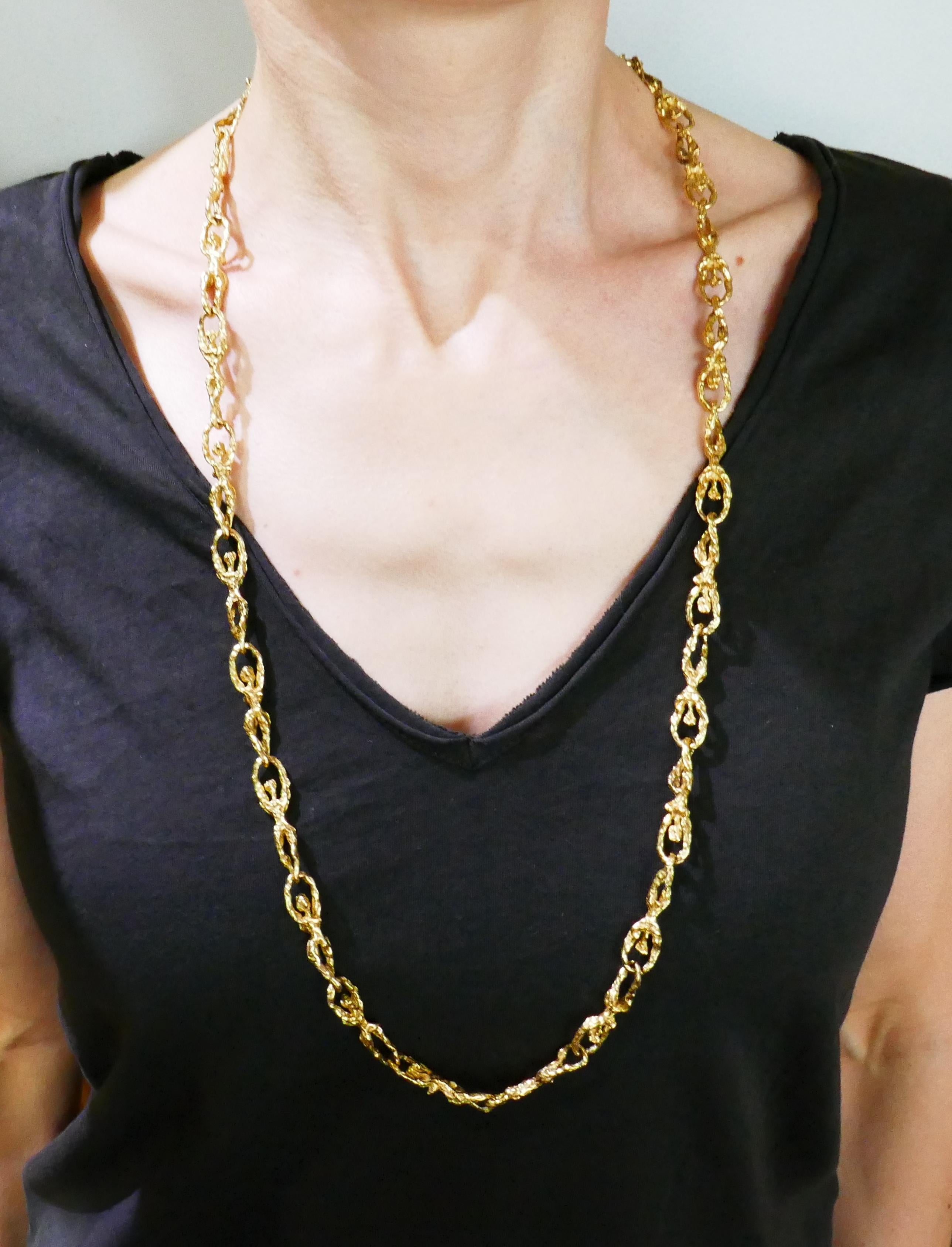 Elegant and stylish textured link chain necklace created in France in the 1980s. Links are designed as a man's and woman's bodies. Substantial and wearable, the necklace is a great addition to your jewelry collection. You will enjoy wearing it on