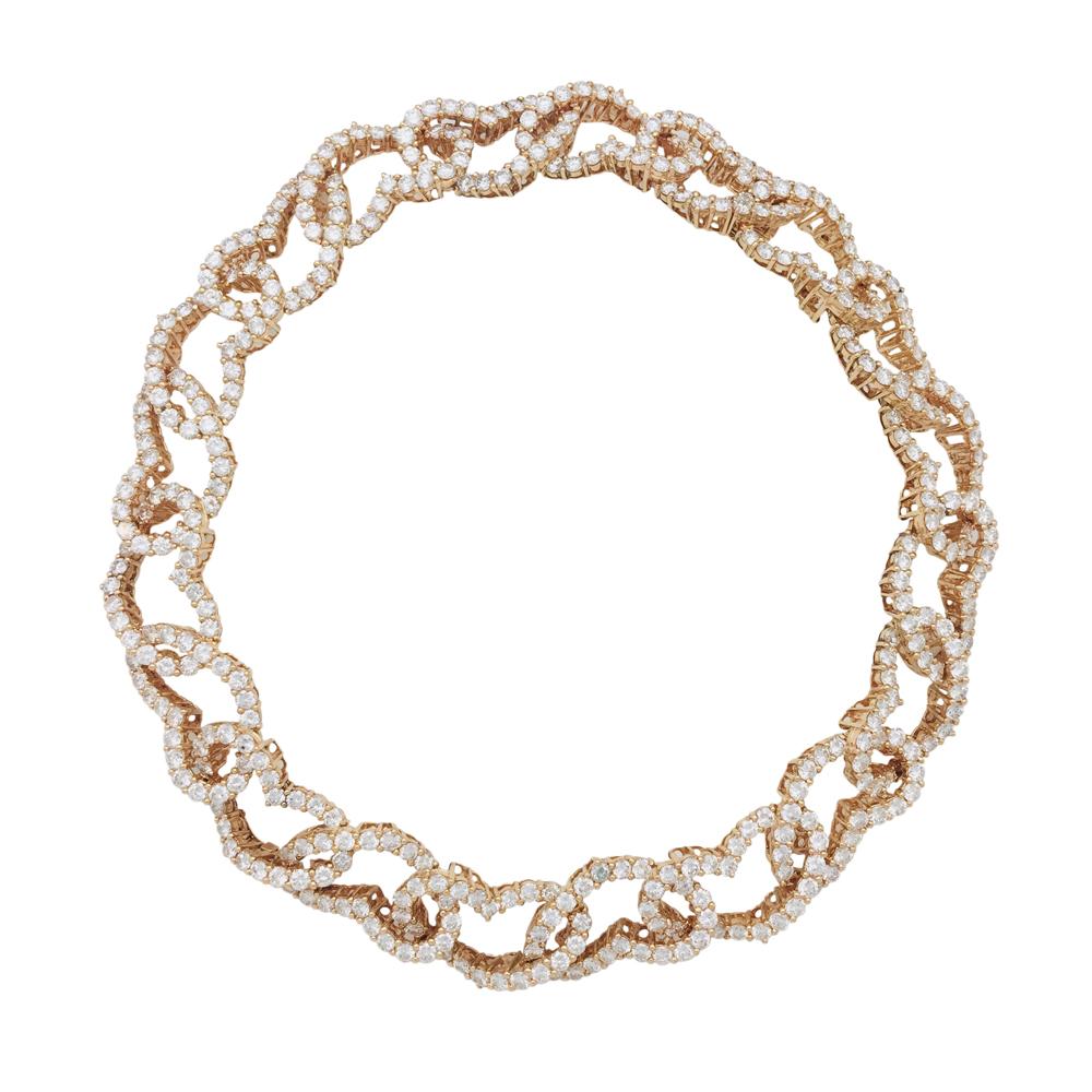 18 kt yellow gold high jewellery short necklace, signed CHAUMET Paris, stamped Or750 with the french hallmark and numbered. The necklace is a full repetitive pattern of open hearts, each facing opposite to its neighbour link. Each heart holds full