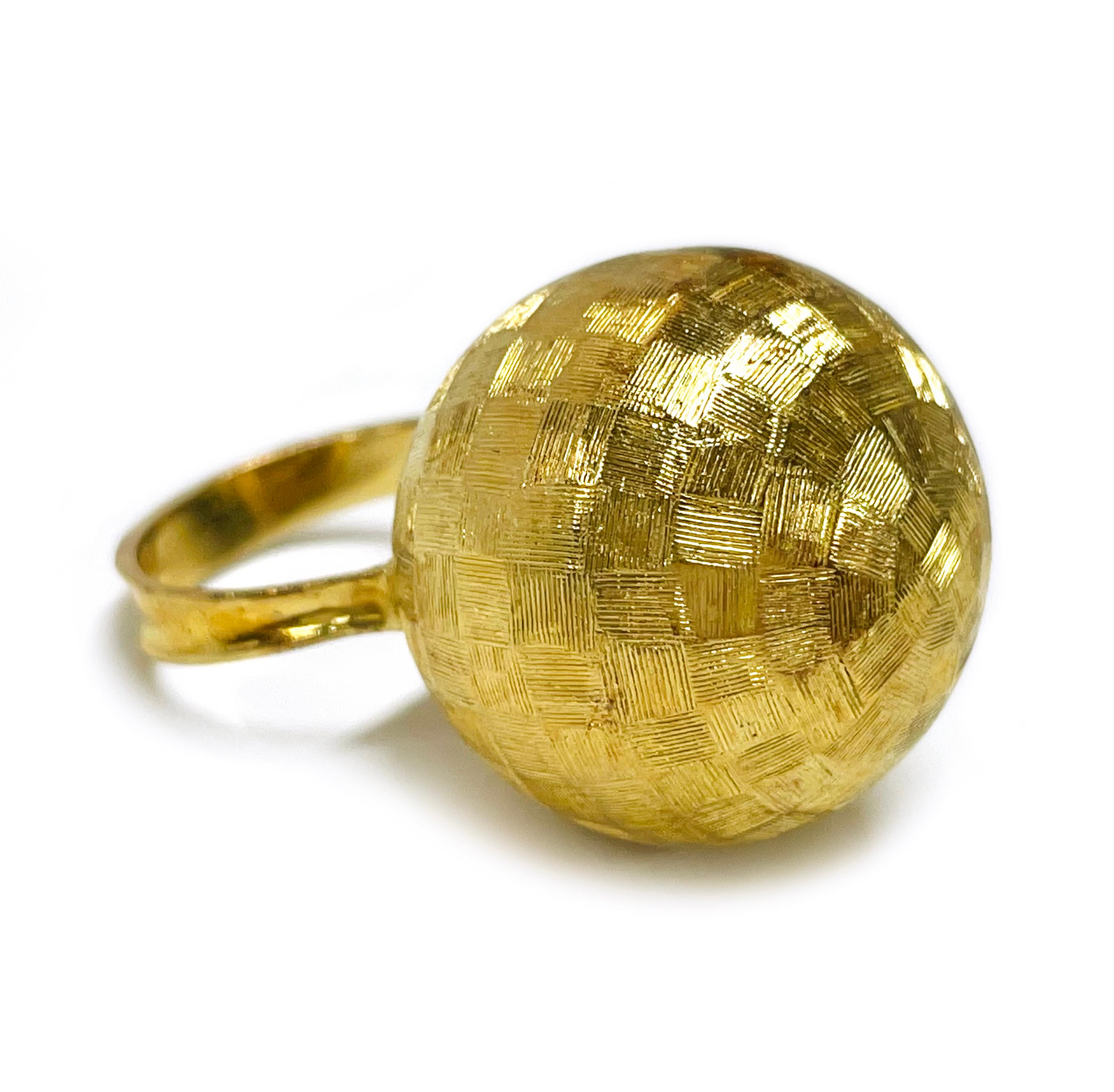 18 Karat Yellow Gold Checkerboard Pattern Dome Ring. The ring features a curved tapered band with a large sphere atop. The hollow sphere has a checkboard pattern and measures 21.7mm in diameter. The ring size is 7 1/4. The total weight of the ring