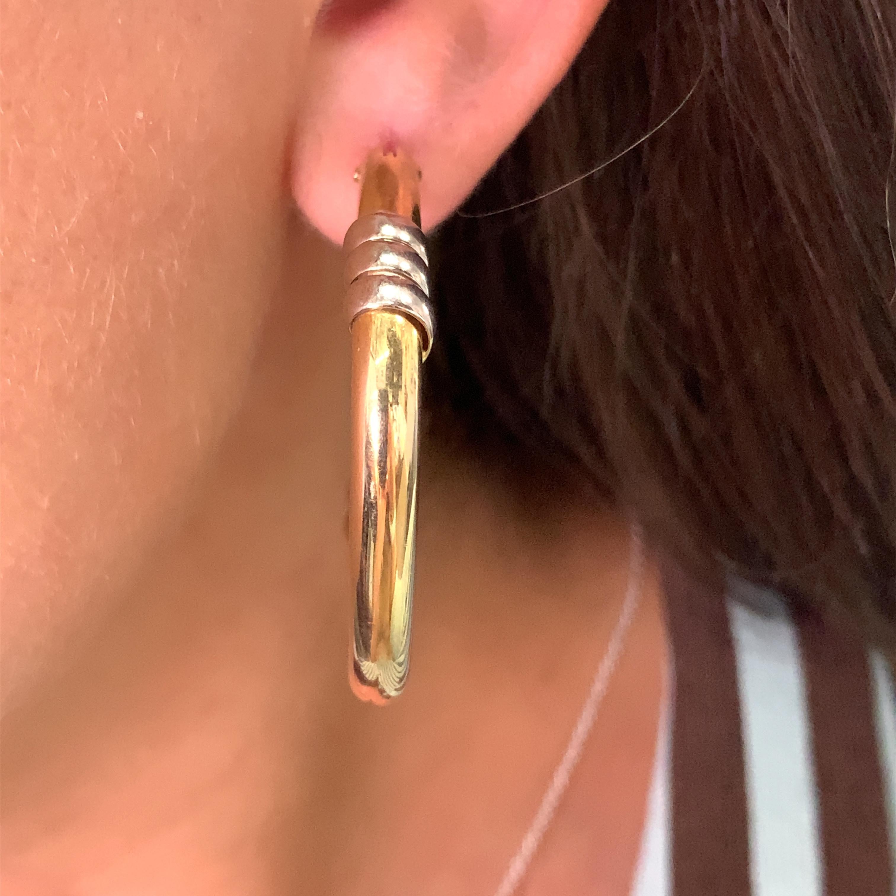 9ct Yellow gold plain hoops earrings.

Hollow yellow and white gold hoops earrings plain square shaped

Hallmarked

Box and valuation included

Weight 10.9g

Large chunky hoops huggies earrings
Measuring approximately diameter 44mm, width