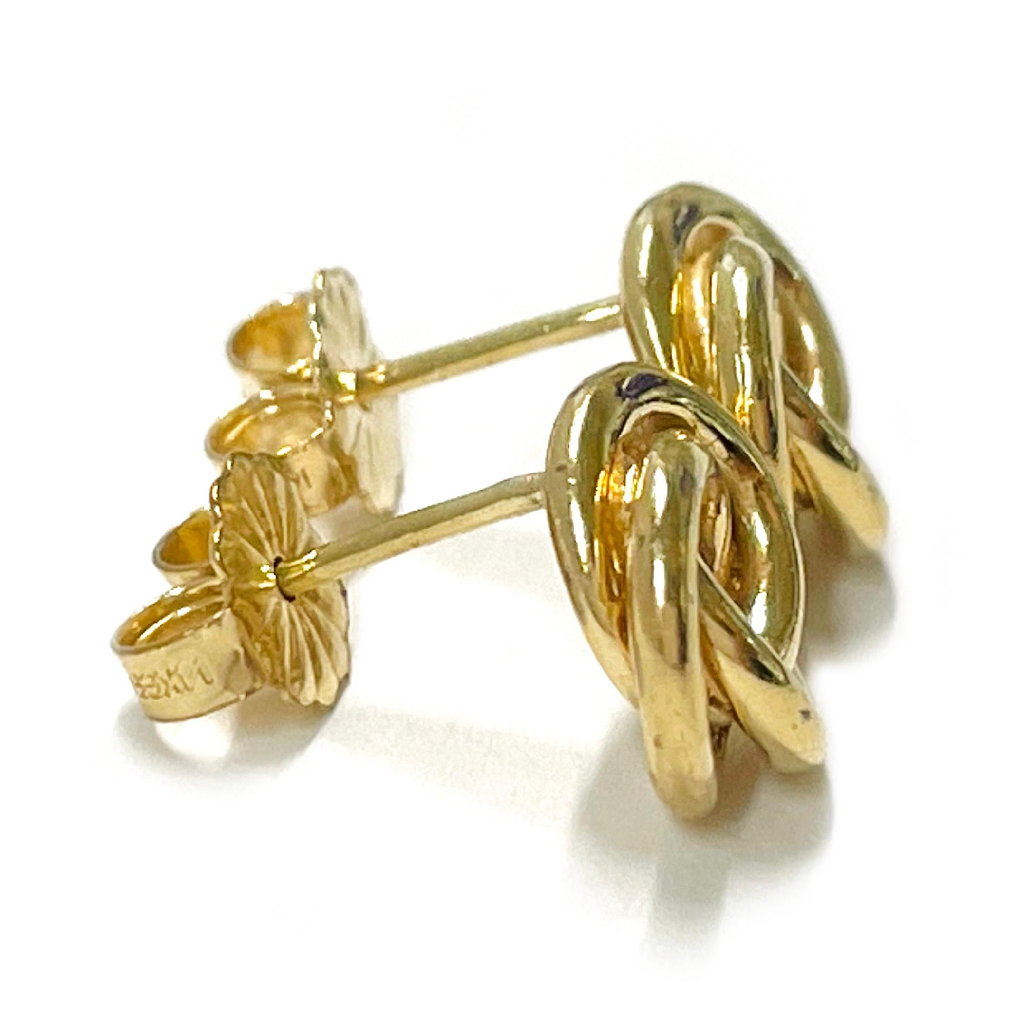 14 Karat Yellow Gold Circle Swirl Stud Earrings. Each earring features a continuous gold tube set in a swirl of circles. The earrings measure approximately 8.7mm x 9.1mm in diameter and have a 14 Karat push back. The total gold weight of the