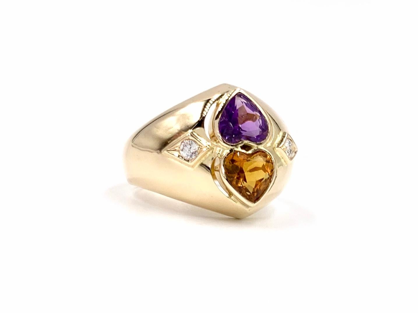 14 Karat yellow gold polished wide ring featuring vibrant heart shape citrine and amethyst gemstones and two round brilliant diamonds. Width of ring measures 17mm and tapers to 4mm under the finger. Diamond quality is approximately G color, VS2