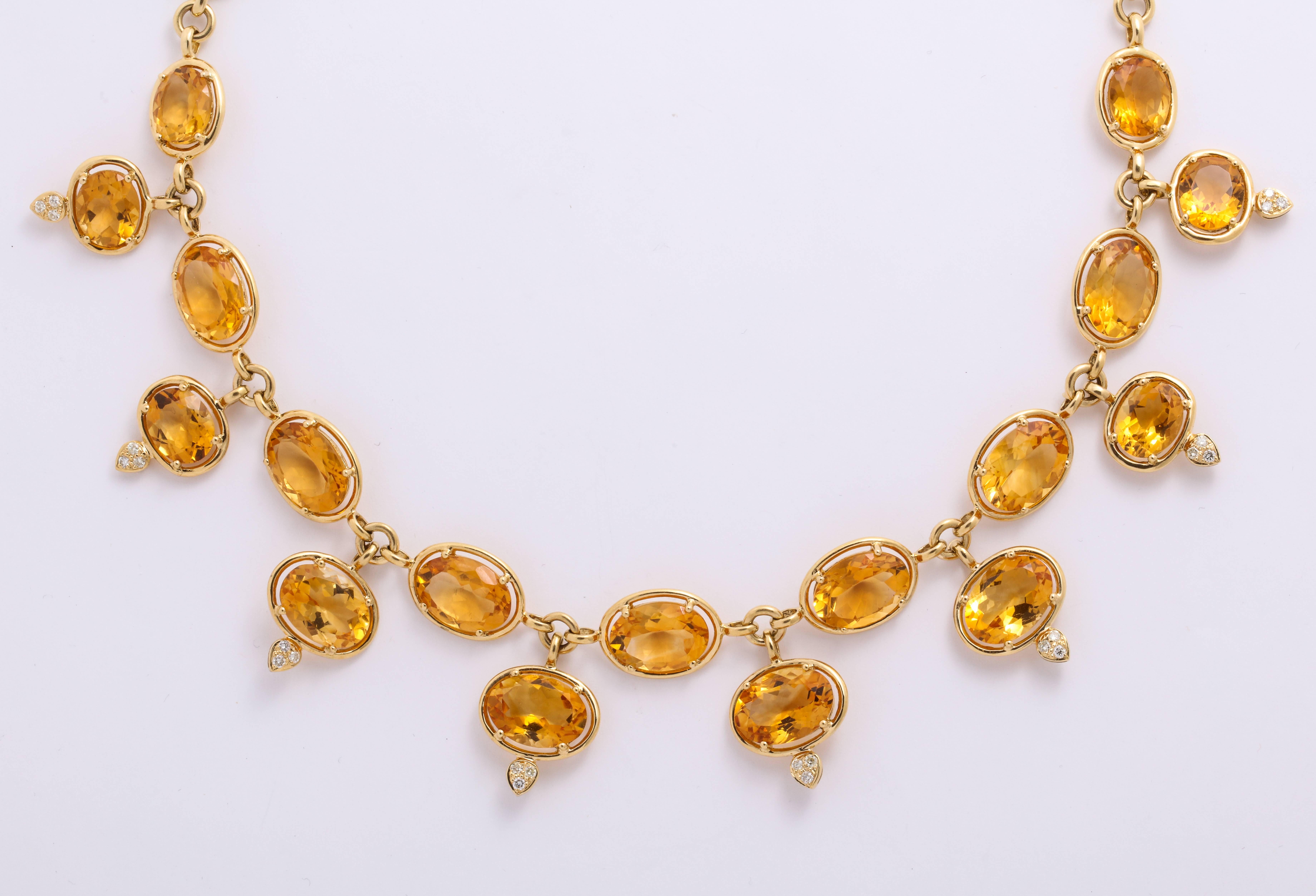 The ''go-to'' casual wear 18 Karat yellow gold link necklace continually mounted with floating oval golden citrine suspending a fringe of articulating citrine: 93.96 carats, with pave'-set round brilliant-cut finials: 0.72 carats 
Dimensions: